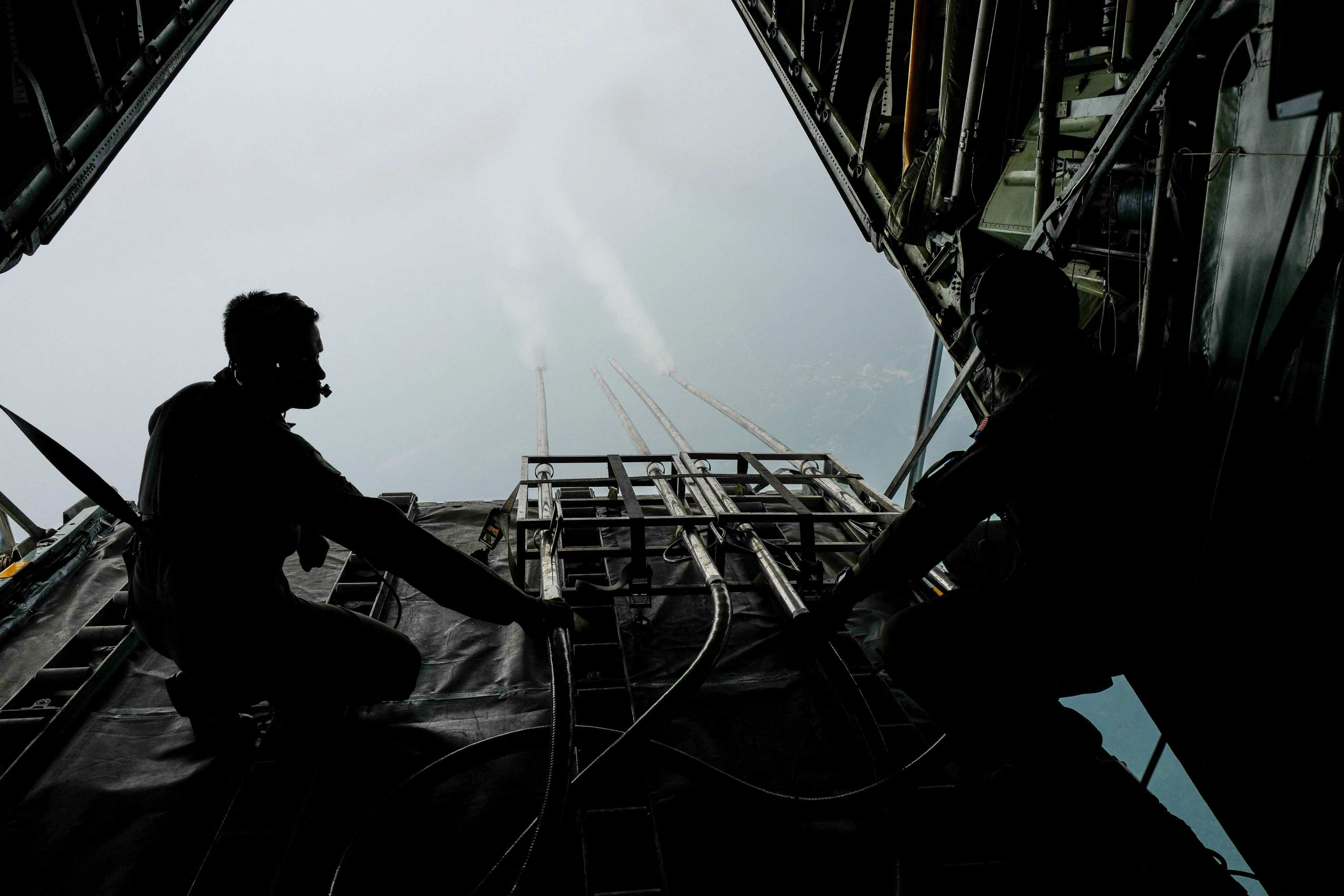 Malaysian air force personnel start the cloud seeding process during a flight over Kedah state in 2019. Photo: AFP