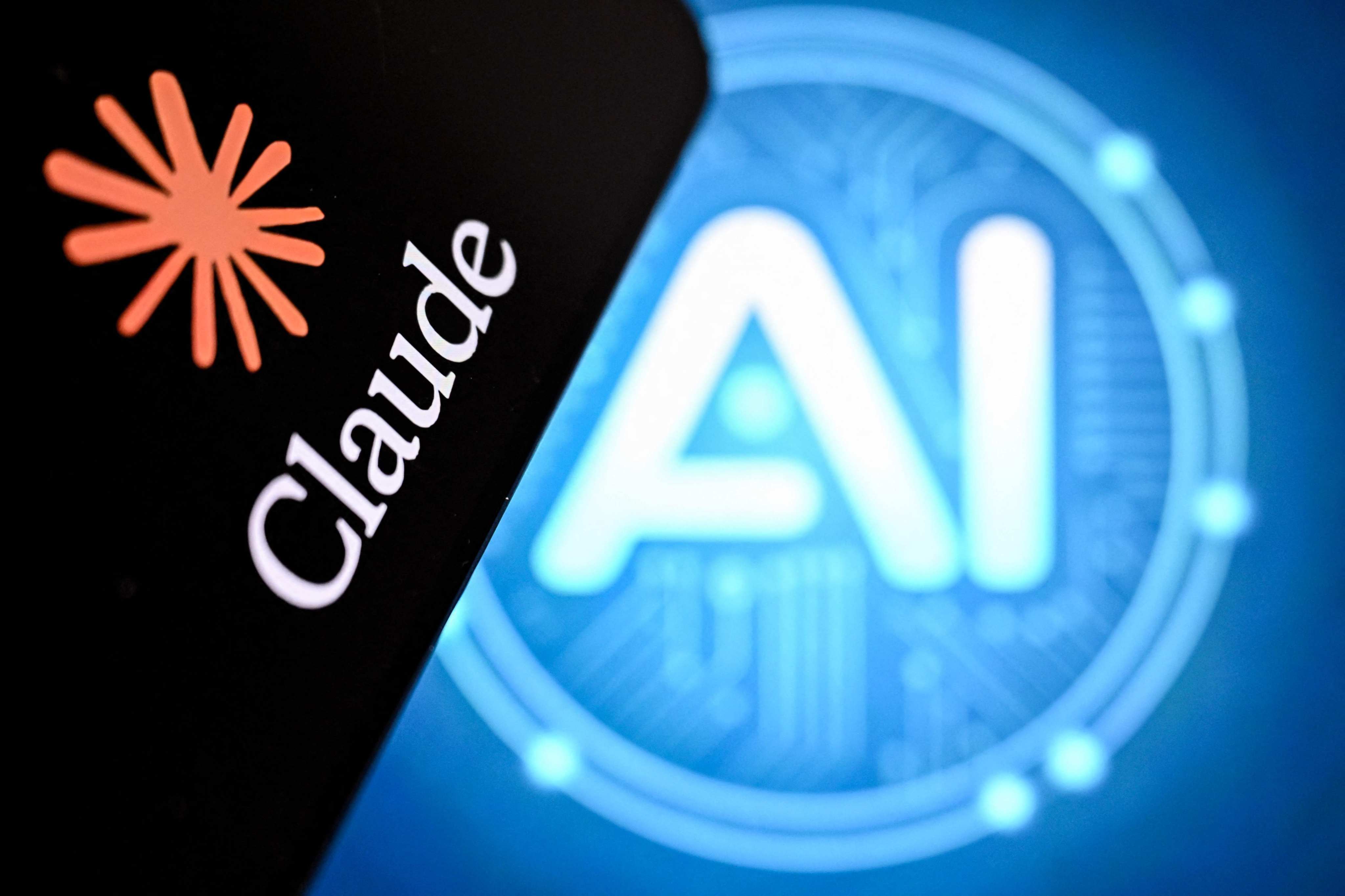 A photo taken on May 7, 2026 shows the letters AI for artificial intelligence on a screen next to the Claude logo. Photo: AFP