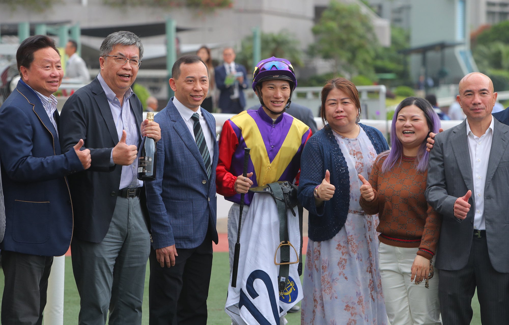 Trainer Cody Mo (third left), jockey Jerry Chau and Jolly Jumper's associates celebrate.