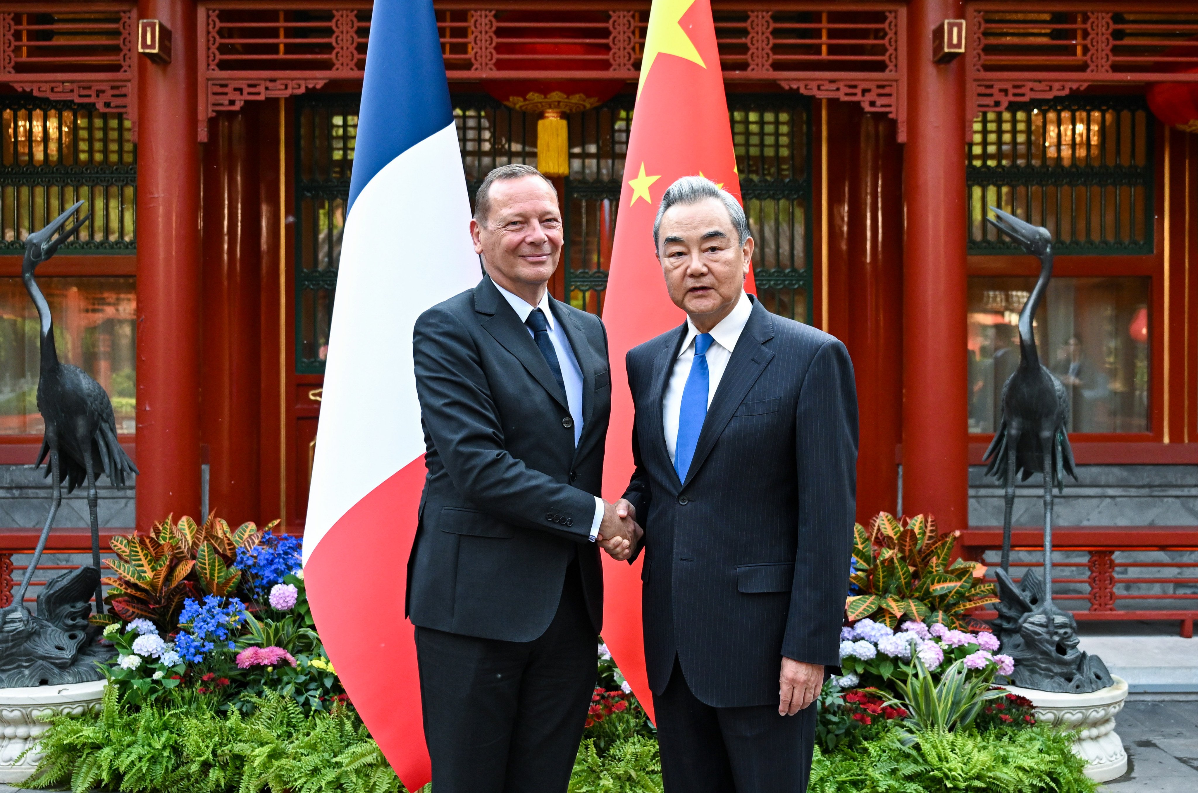 China’s top diplomat Wang Yi (right) shakes hands with Emmanuel Bonne, diplomatic adviser to the French president, in Beijing on May 8, 2026. Photo: Xinhua