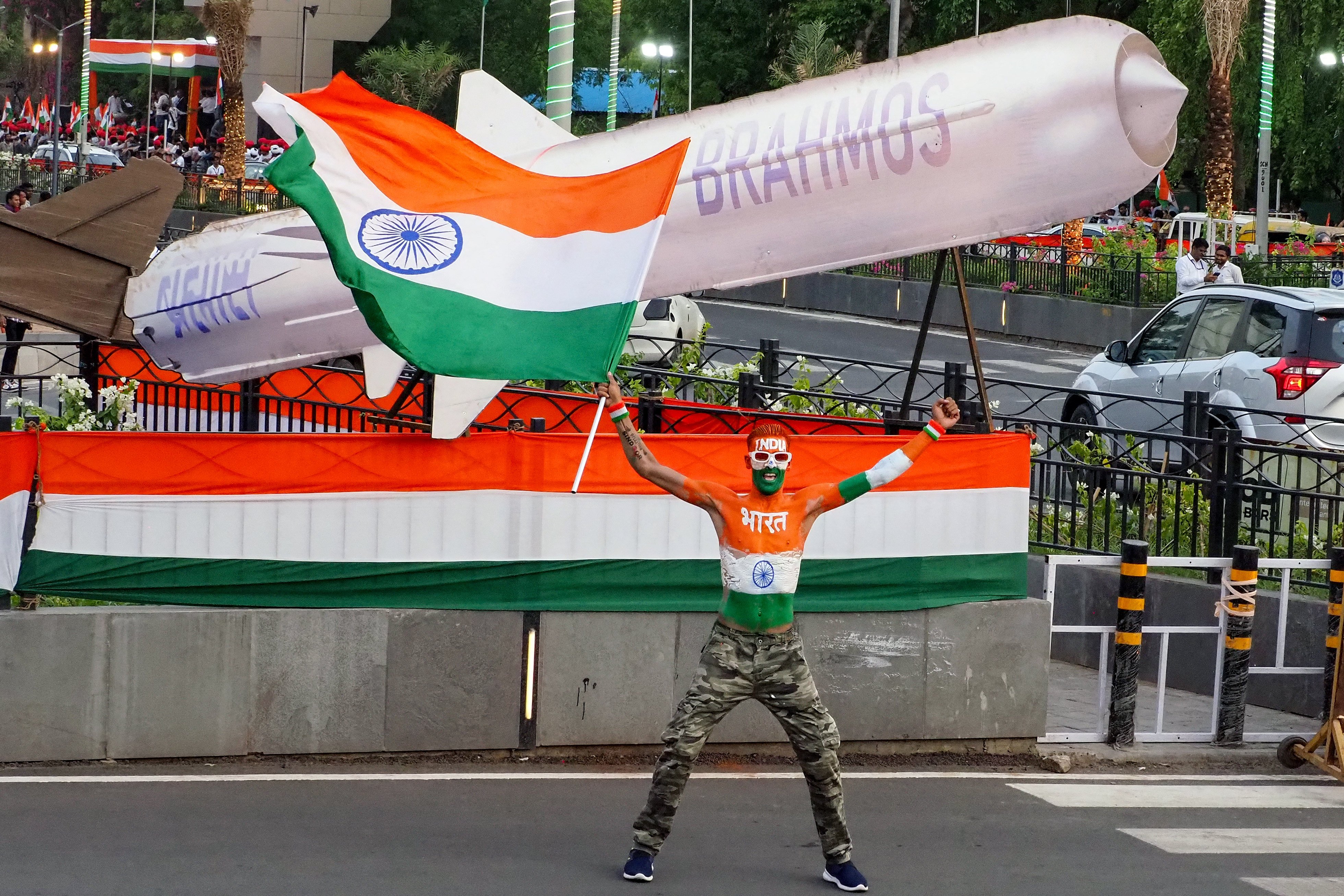 A man waves India’s national flag in front of a replica of the BrahMos missile system in Ahmedabad last year. Photo: AFP