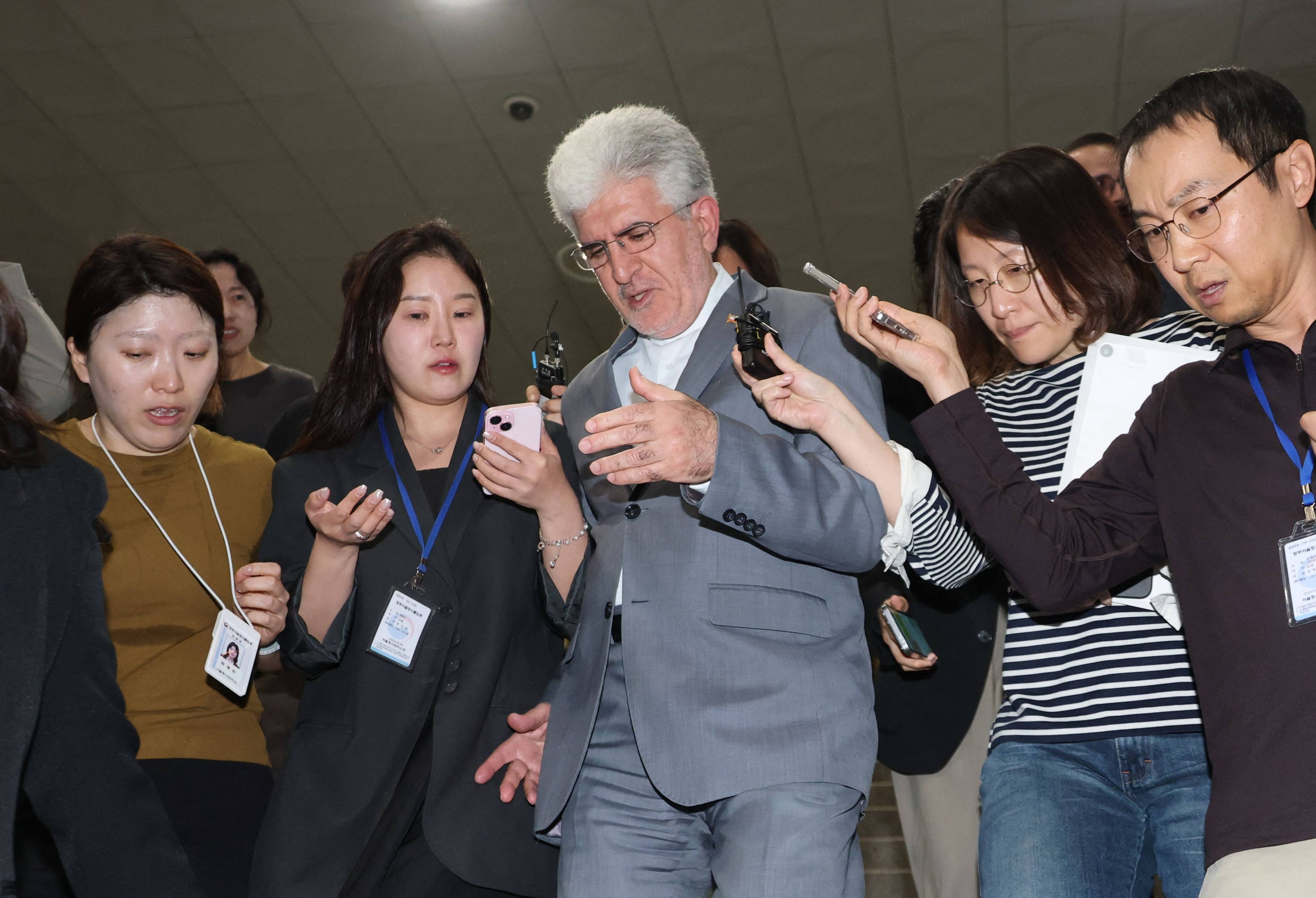 Iranian ambassador to South Korea Saeed Koozechi (centre) leaves the Foreign Ministry in Seoul on Sunday. Photo: AFP