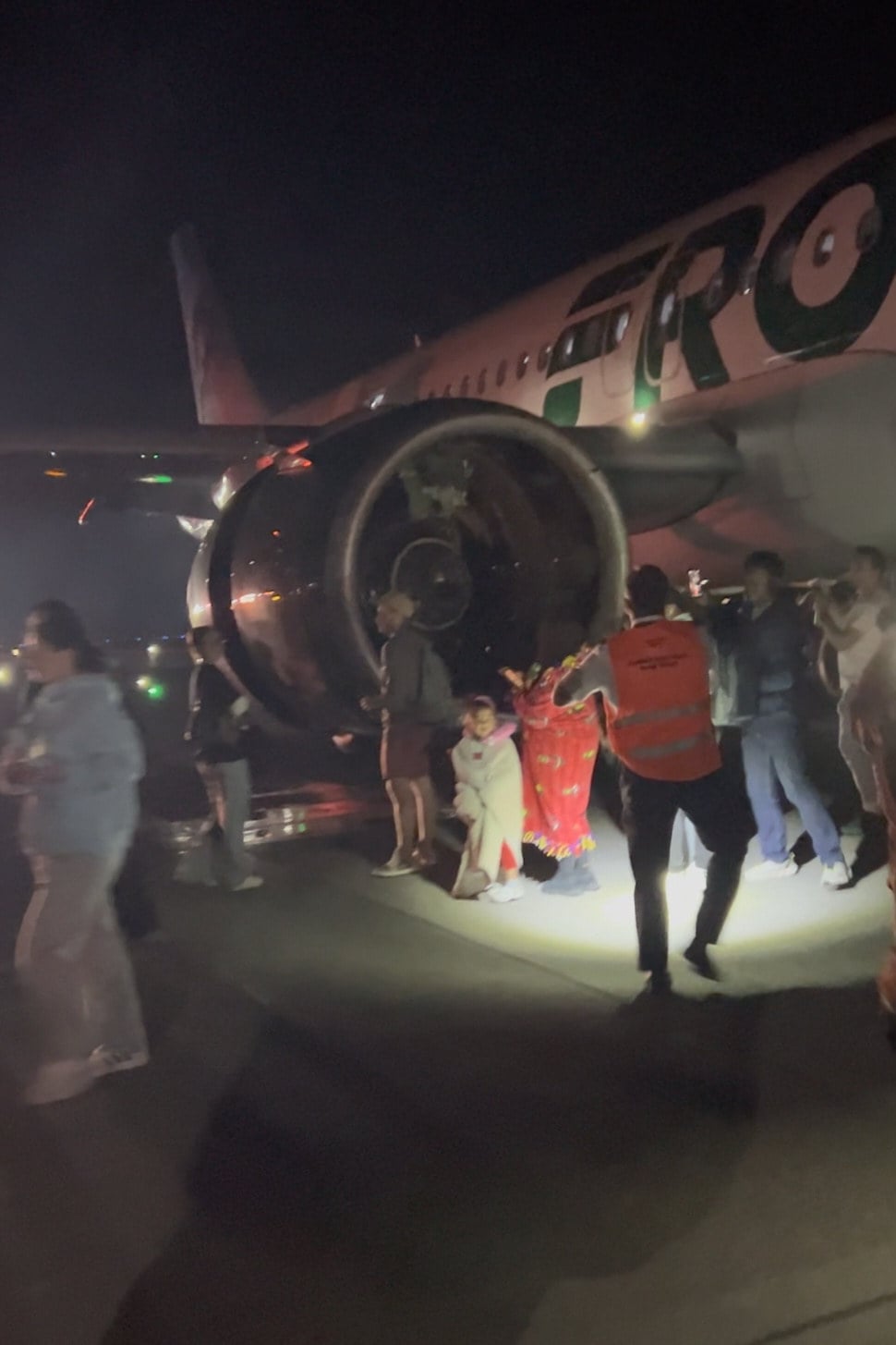 Passengers evacuate after a person was struck and killed by a Frontier Airlines plane at Denver International Airport on Friday. Photo: Jack Estenssoro via AP