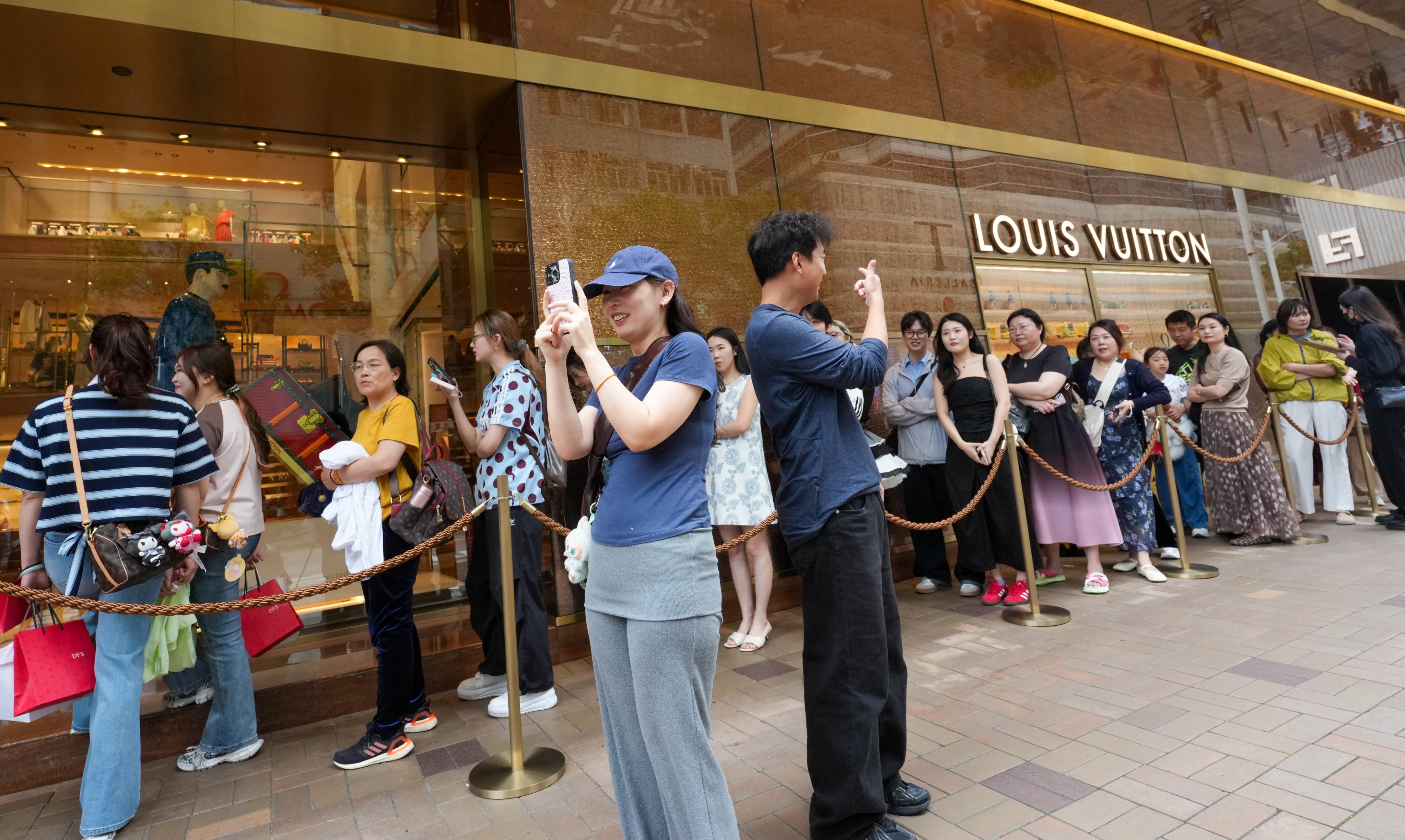 Shoppers queue and snap photos in Tsim Sha Tsui in early May. Photo: Jelly Tse