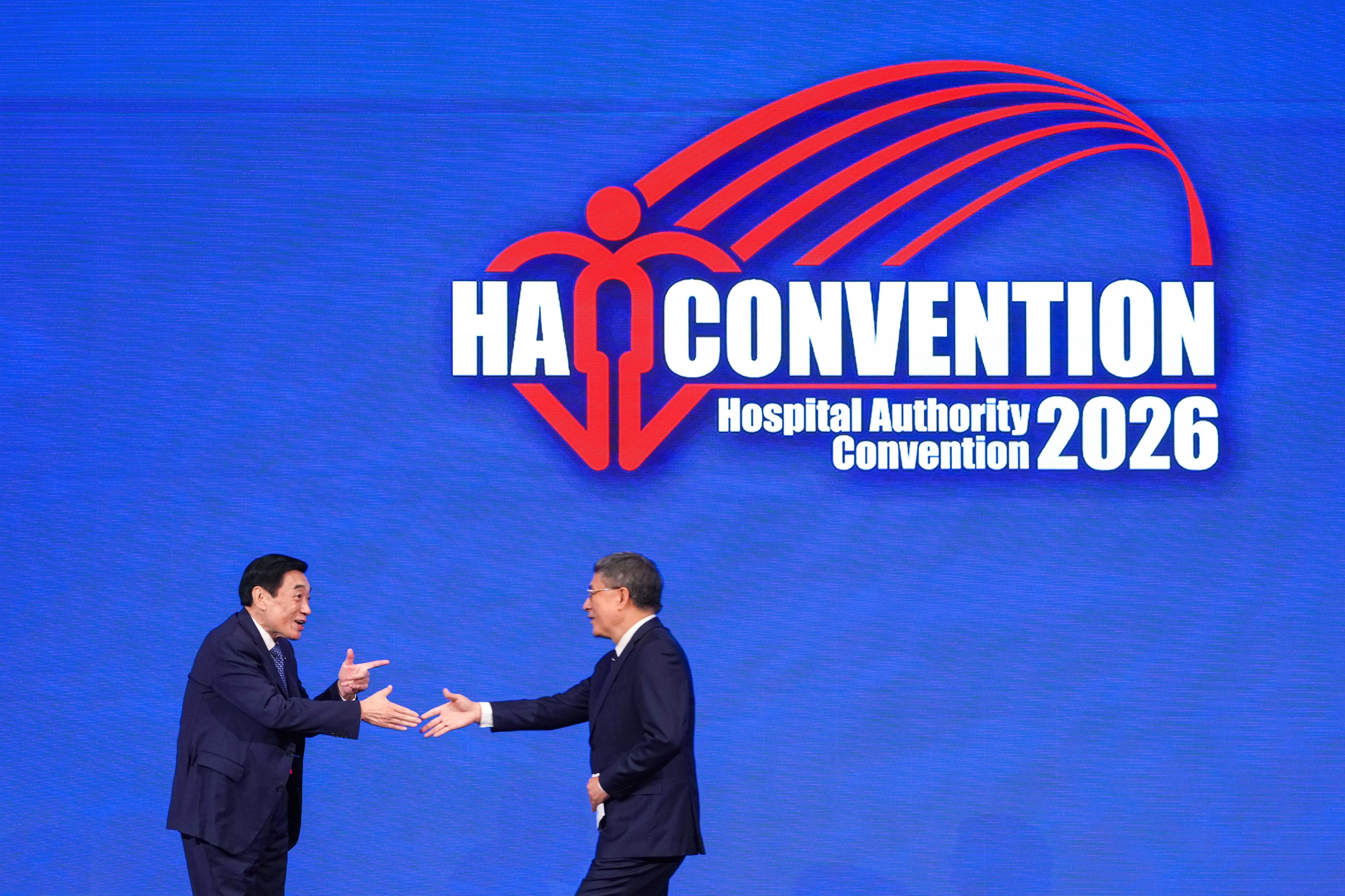 Hospital Authority chairman Henry Fan Hung-ling (left) and acting chief secretary Cheuk Wing-hing greet each other at the Hong Kong Convention and Exhibition Centre. Photo: Sam Tsang