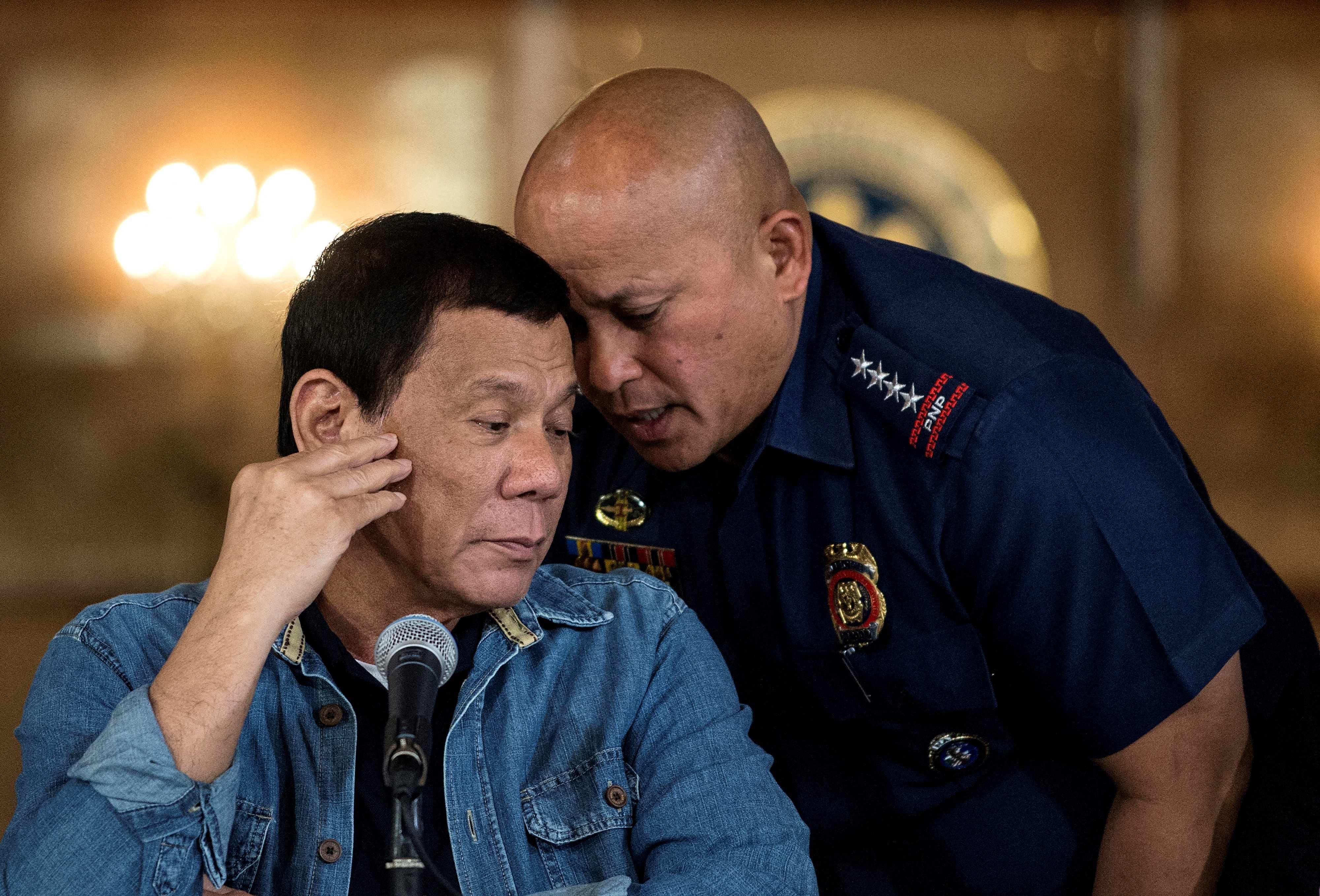 Former Philippine president Rodrigo Duterte (left) listens to Ronald Dela Rosa, then-director general of the Philippine National Police, during a press conference at the Malacanang palace in Manila in 2017. Photo: AFP