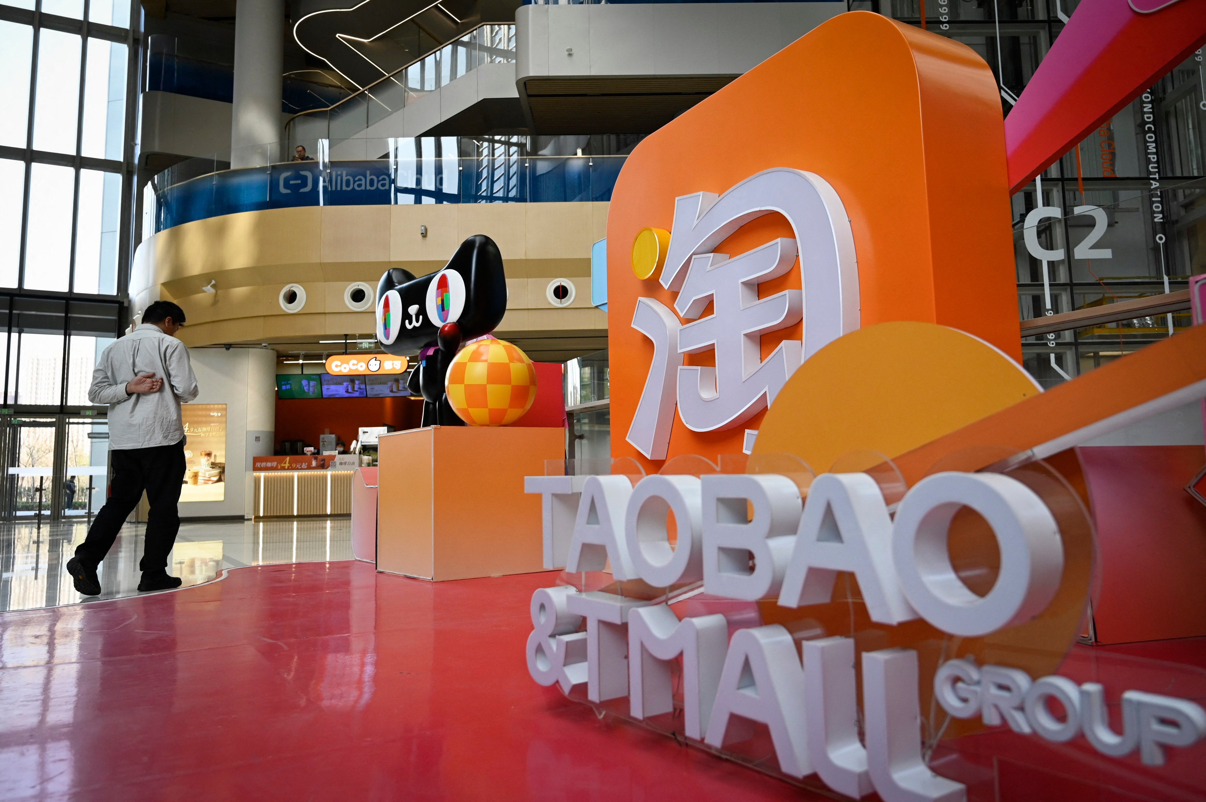 A man walks past a Taobao and Tmall installation at the Alibaba office in Beijing. Photo: AFP