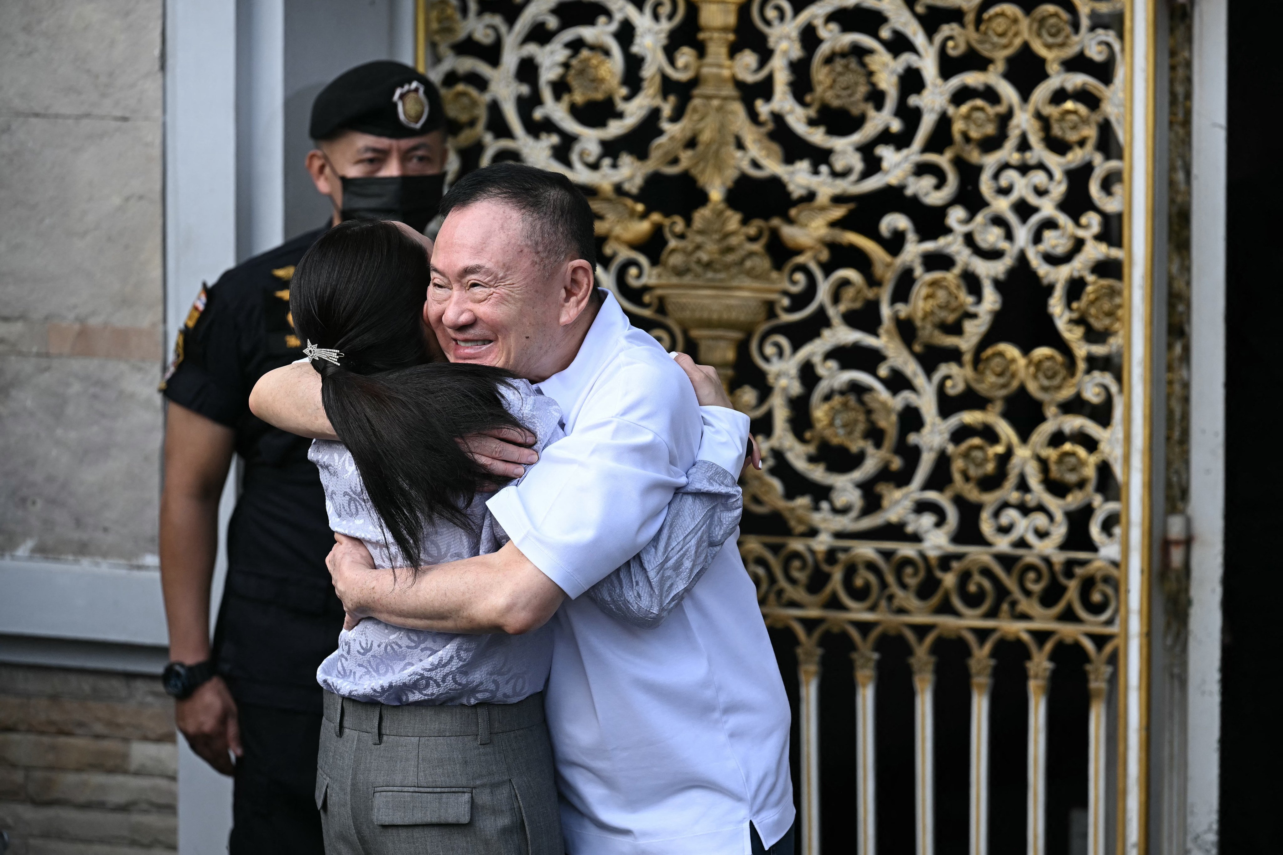 Thailand’s former prime minister Thaksin Shinawatra (R) hugs his daughter Paetongtarn Shinawatra upon his release at Klong Prem Central Prison in Bangkok on May 11, 2026. Thailand’s former prime minister Thaksin Shinawatra was released early from prison on May 11, raising the prospect of a return to the spotlight for the political heavyweight. (Photo by Lillian SUWANRUMPHA / AFP)