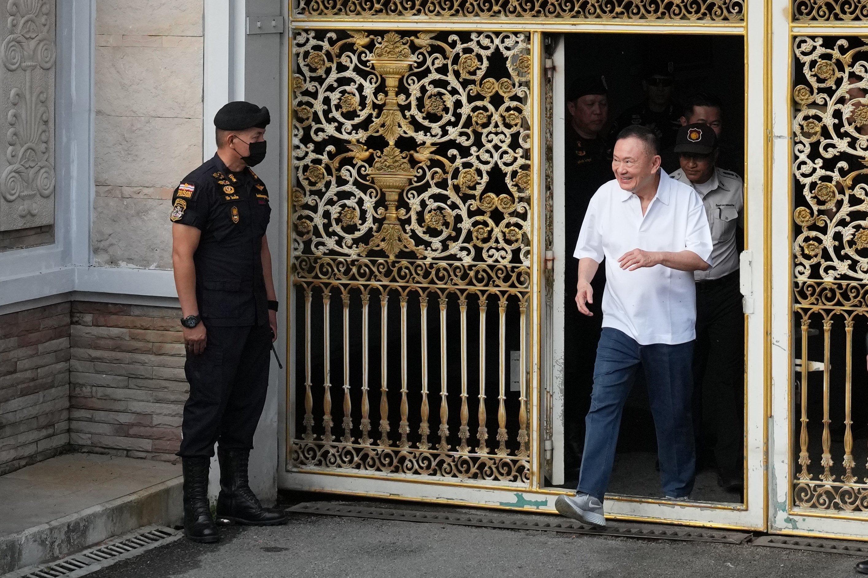 Former Thai Prime Minister Thaksin Shinawatra smiles as he walks out from Klong Prem Central Prison in Bangkok on Monday. Photo: AP