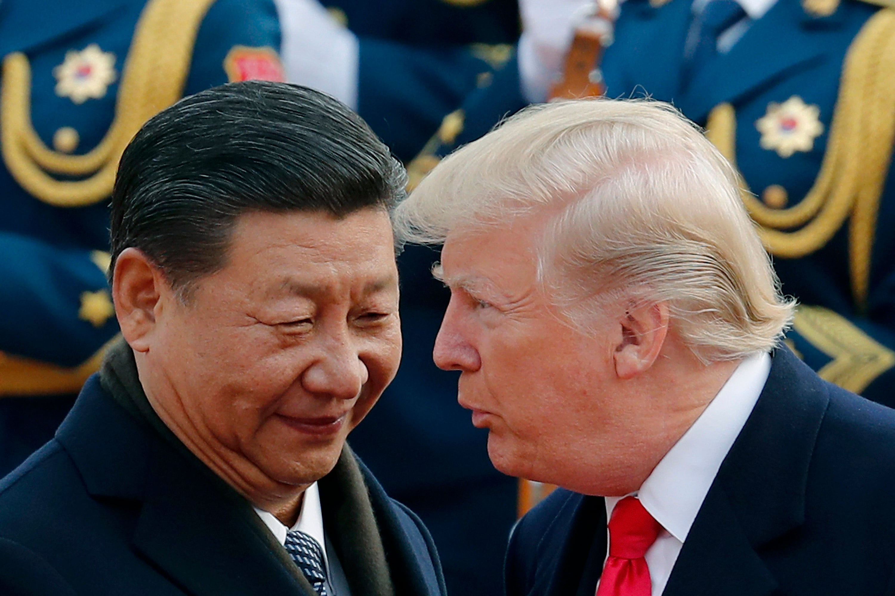 Donald Trump chats with Xi Jinping during a welcome ceremony at the Great Hall of the People in Beijing on November 9, 2017. Photo: AP