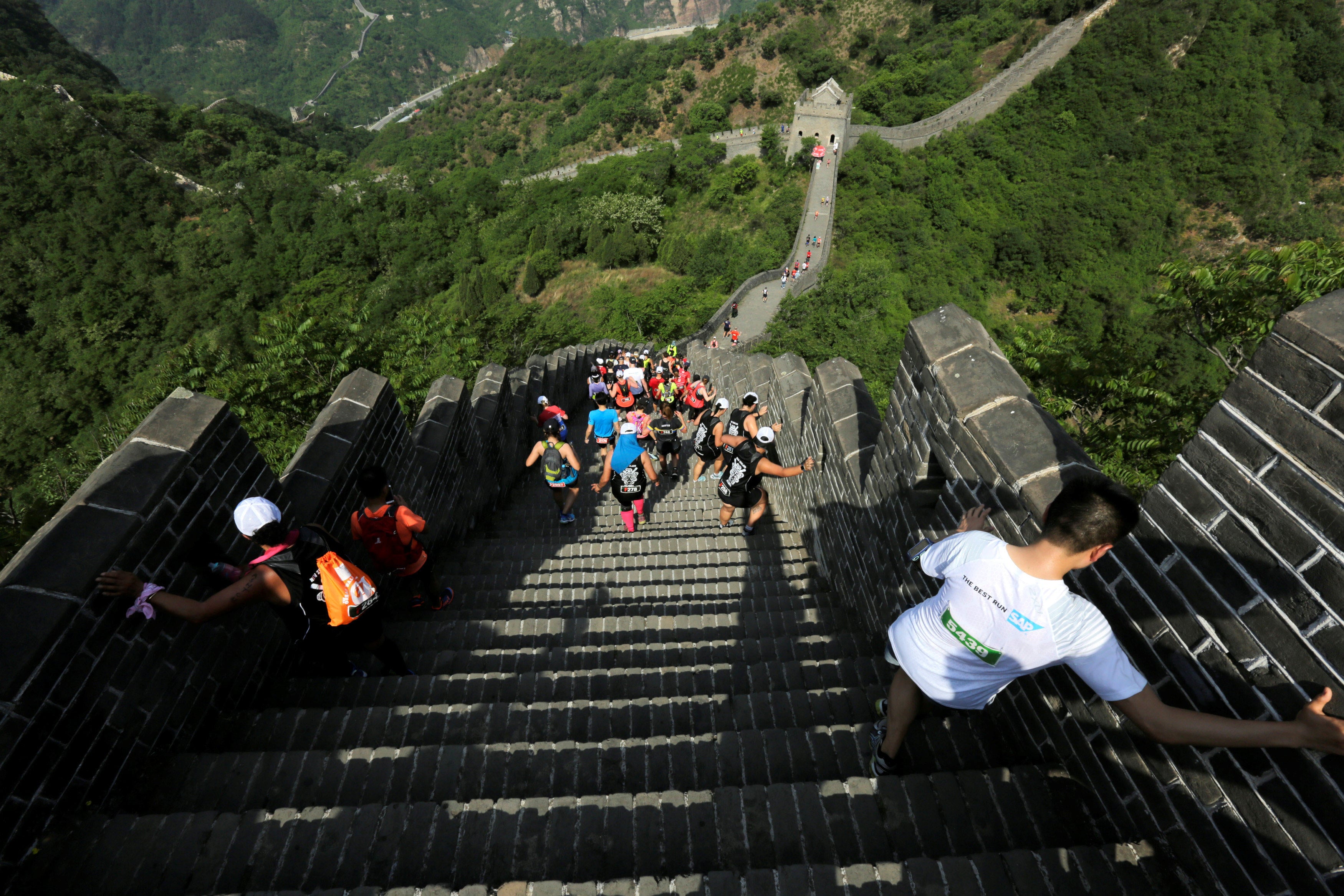 Full-marathon runners will tackle 5,164 steps on the Great Wall, with some slopes said to be as steep as 70 degrees and requiring runners to use their hands to climb. Photo: Reuters