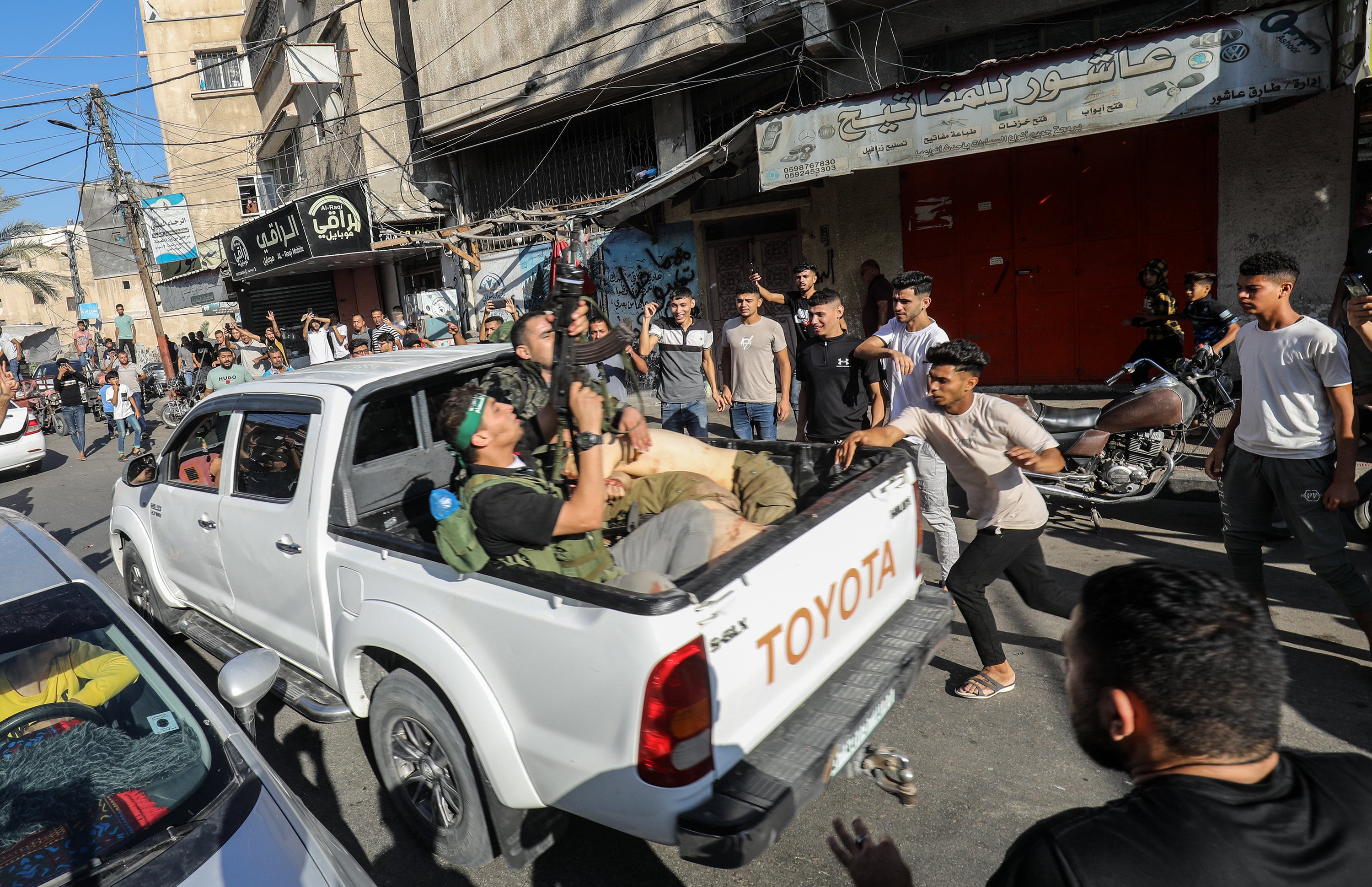 Palestinians surround a vehicle with a hostage after crossing into Gaza on October 7, 2023. Photo: dpa