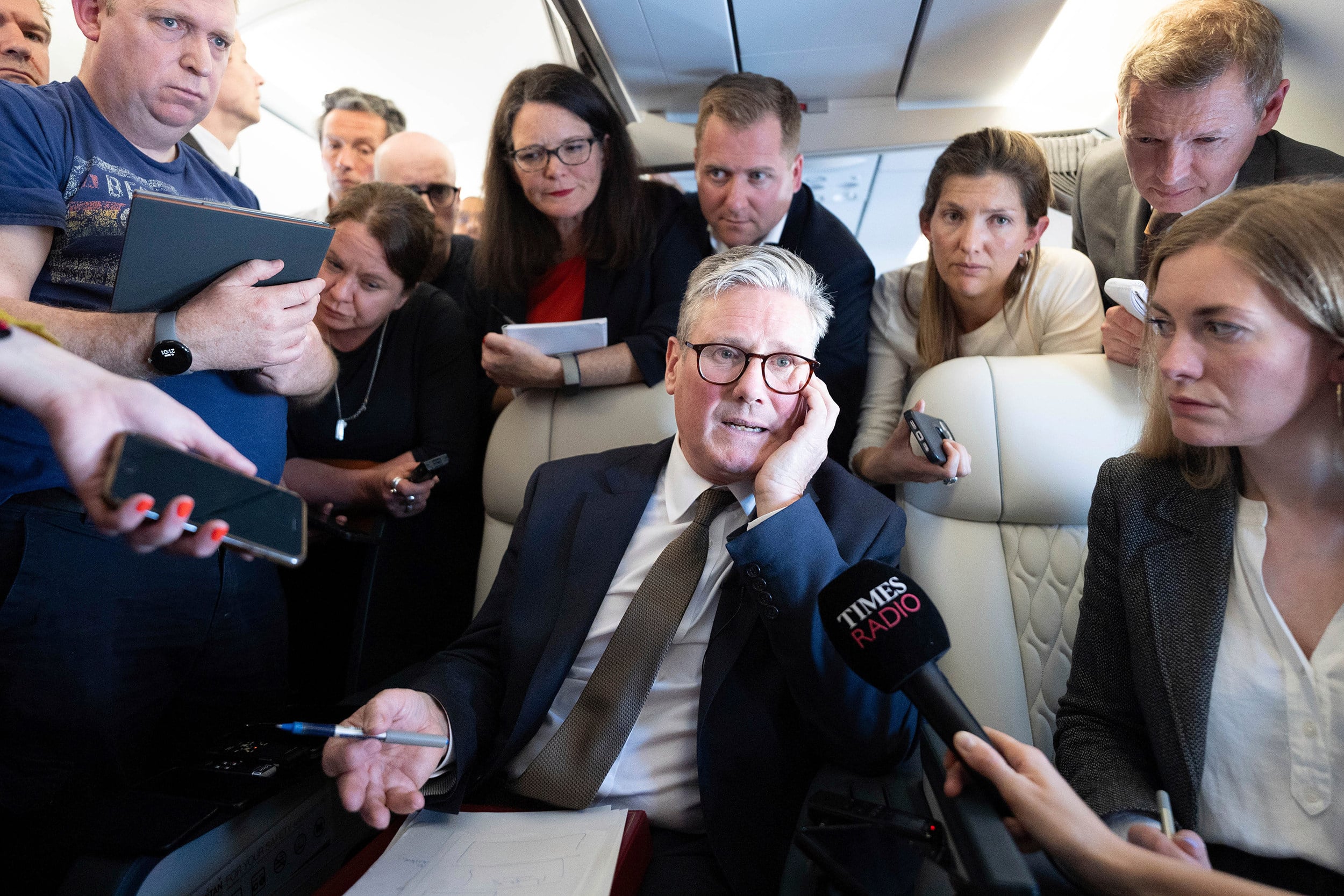Britain’s Prime Minister Keir Starmer talks to journalists onboard a plane to Washington DC in 2024. He has promised to press on with a premiership that has been dogged by scandal and policy ​U-turns since he won a large majority at a national election in 2024. Photo: via AP