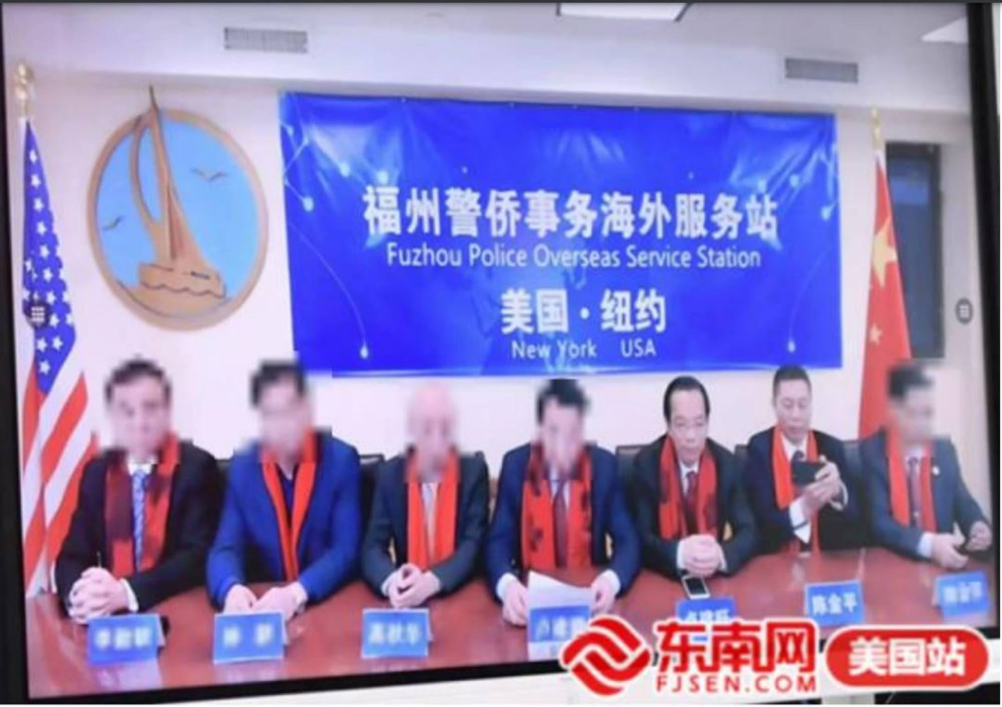 Sitting in front of a banner reading “Fuzhou Police Overseas Service Station, New York, USA” are the defendants Lu Jianwang, third from right, and Chen Jinping, second from right. Photo: US Department of Justice