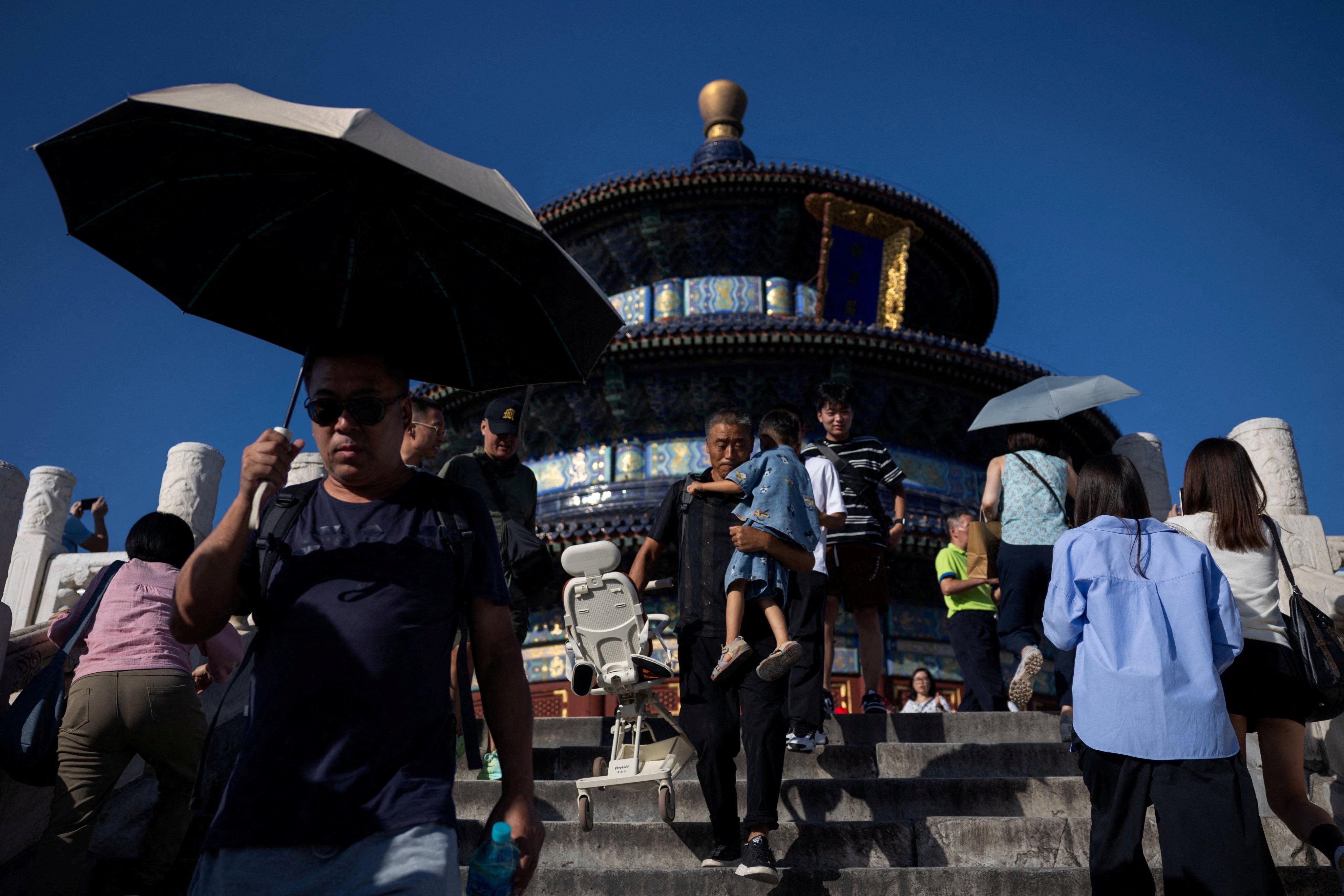 FILE PHOTO: Visitors walk down the stairs in front of the Hall of Prayer for Good Harvests at the Temple of Heaven, or Tiantan Park, in Beijing, China, September 14, 2025. REUTERS/Maxim Shemetov/File Photo