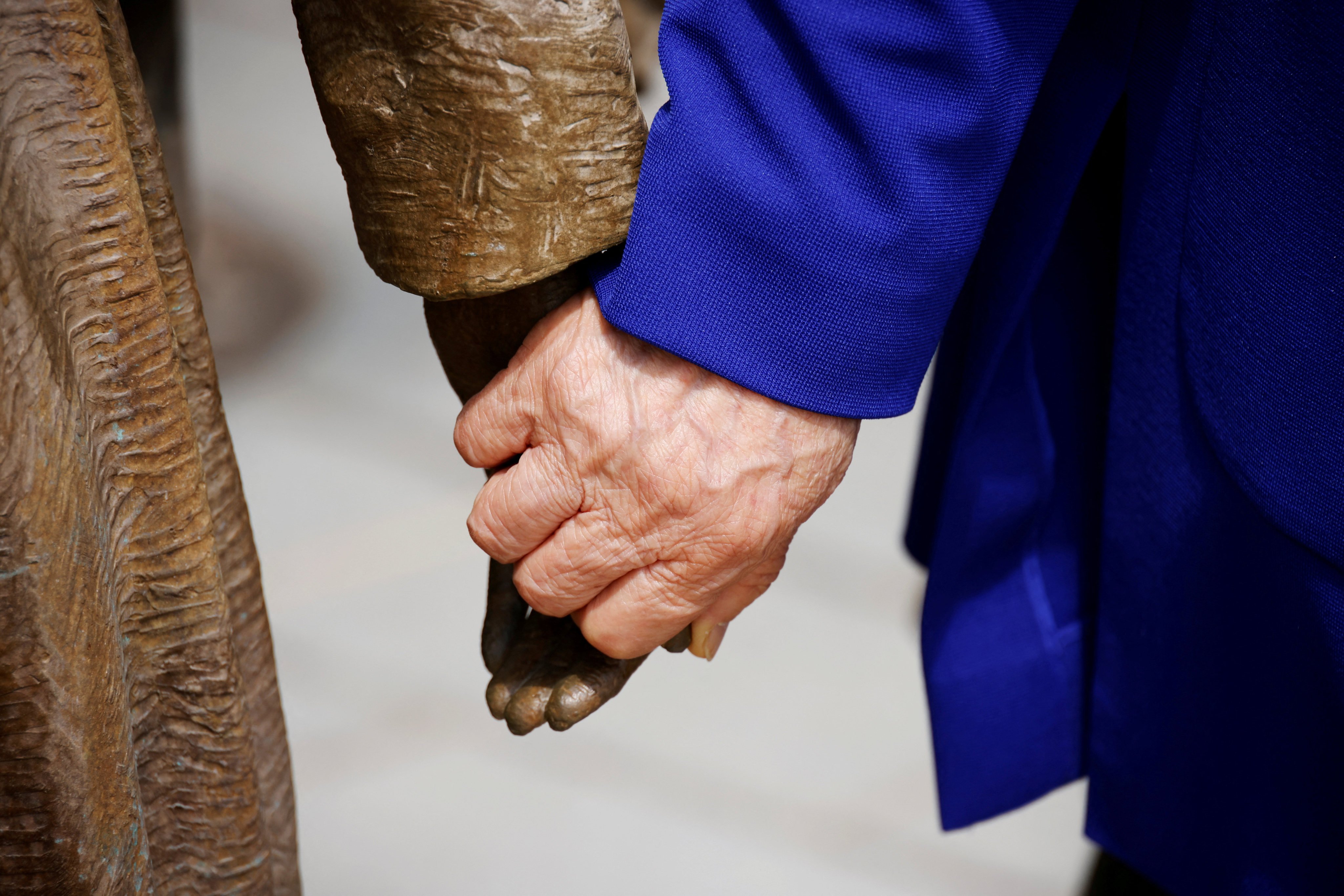 A former South Korean “comfort woman” holds the hand of a statue symbolising Japan’s wartime sex slaves in Seoul in 2021. Photo: Reuters