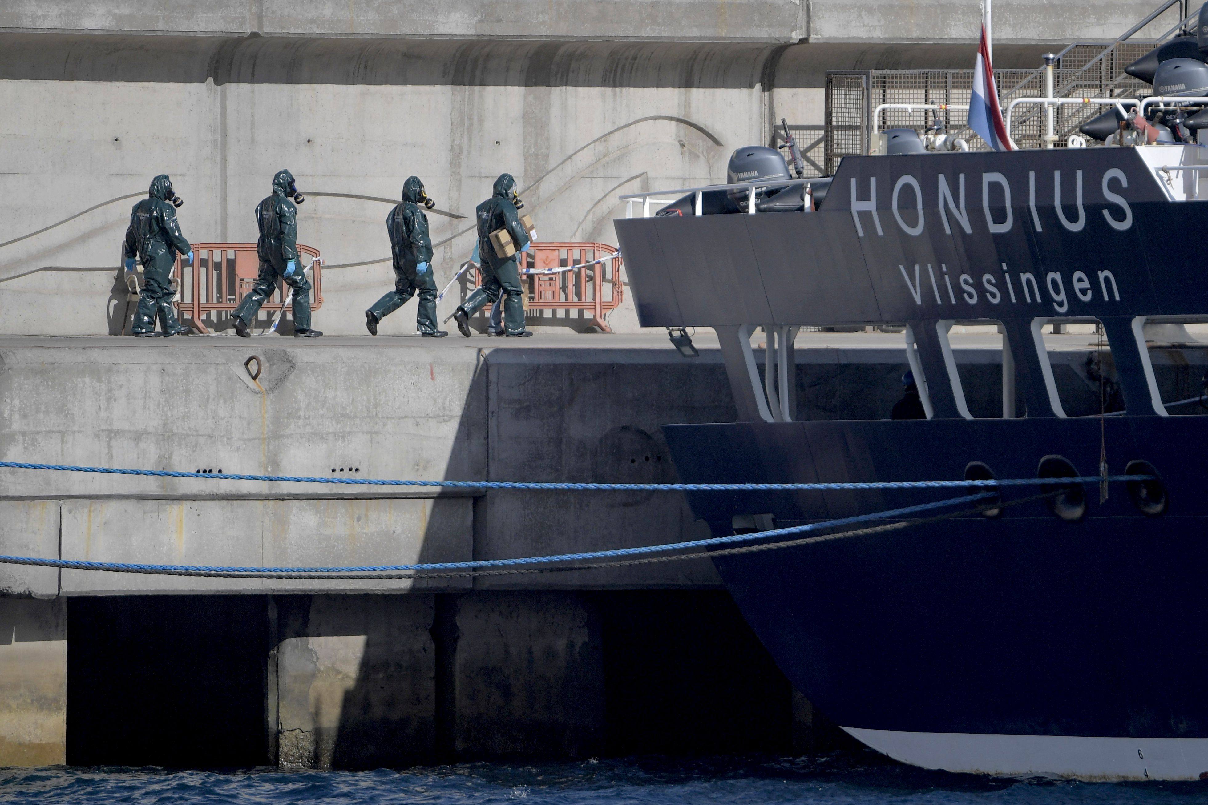 People in protective suits walk towards the MV Hondius on the island of Tenerife, Spain’s Canary Islands on May 11. Photo: AFP