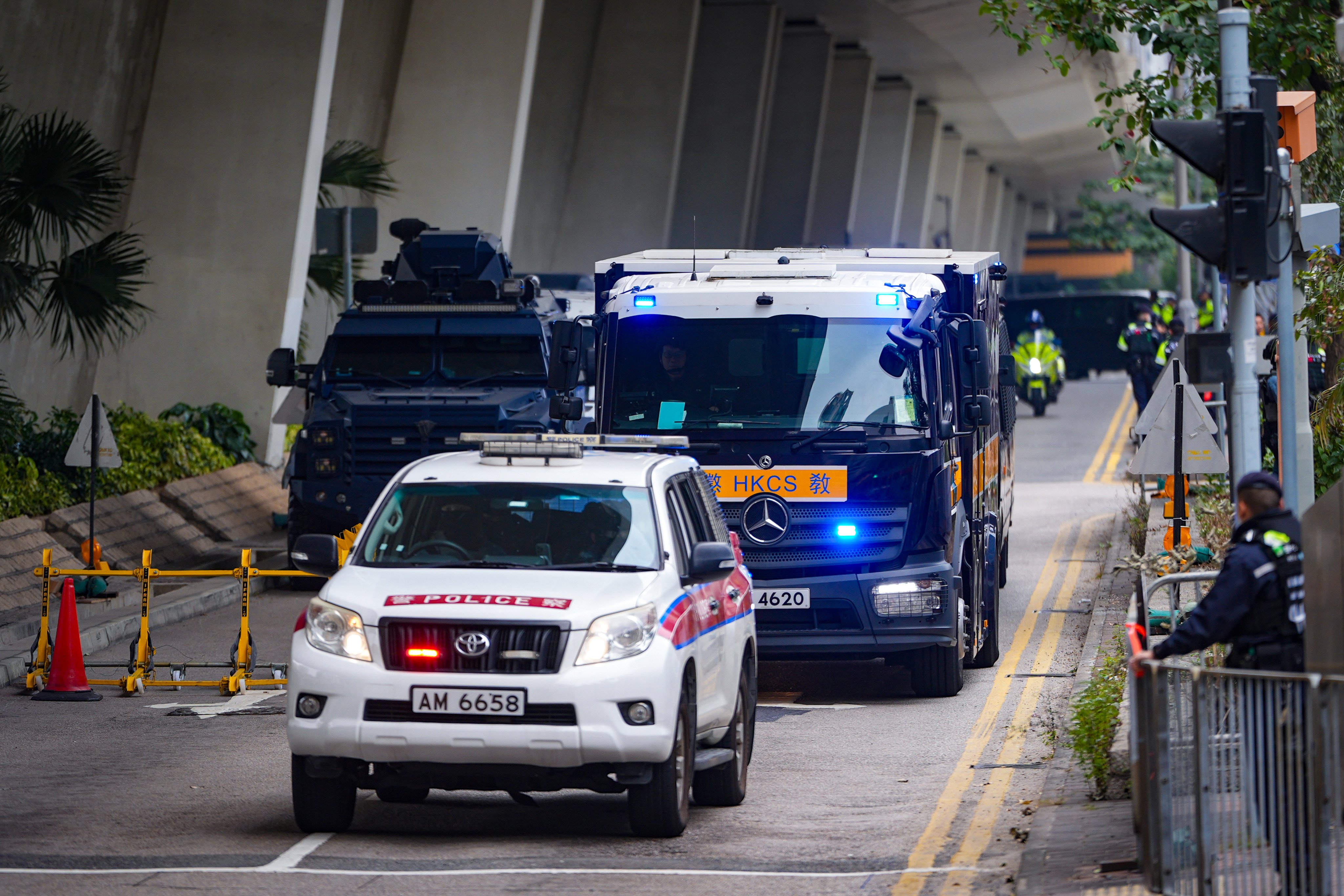 Correctional Services Department vehicles leave the West Kowloon Court where former media boss Jimmy Lai was sentenced to 20 years in prison for violating the national security law, on February 9. Photo: Eugene Lee