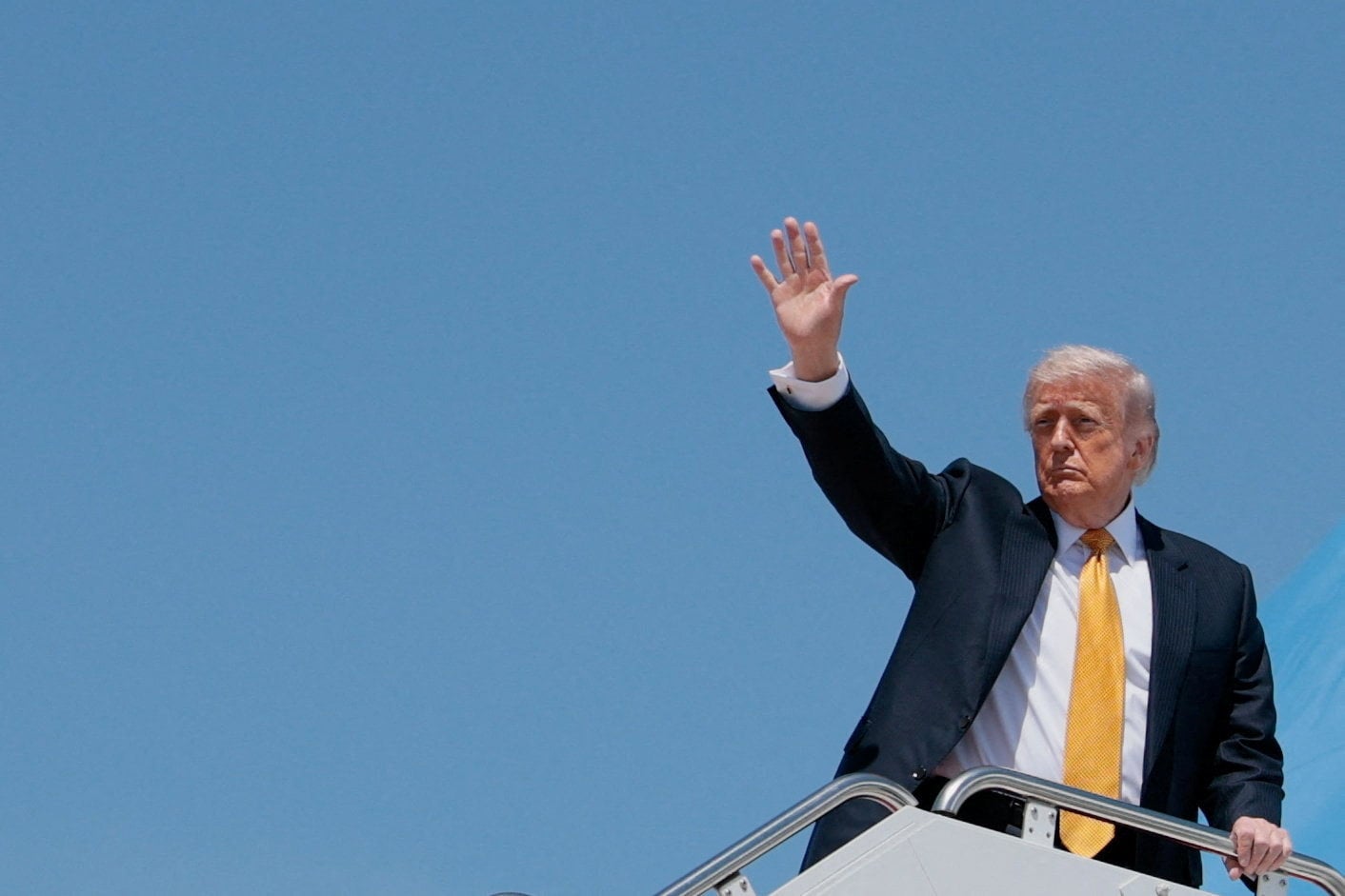 U.S. President Donald Trump waves as he boards Air Force One for a trip to China, at Joint Base Andrews, Maryland, U.S., May 12, 2026. REUTERS/Evan Vucci
