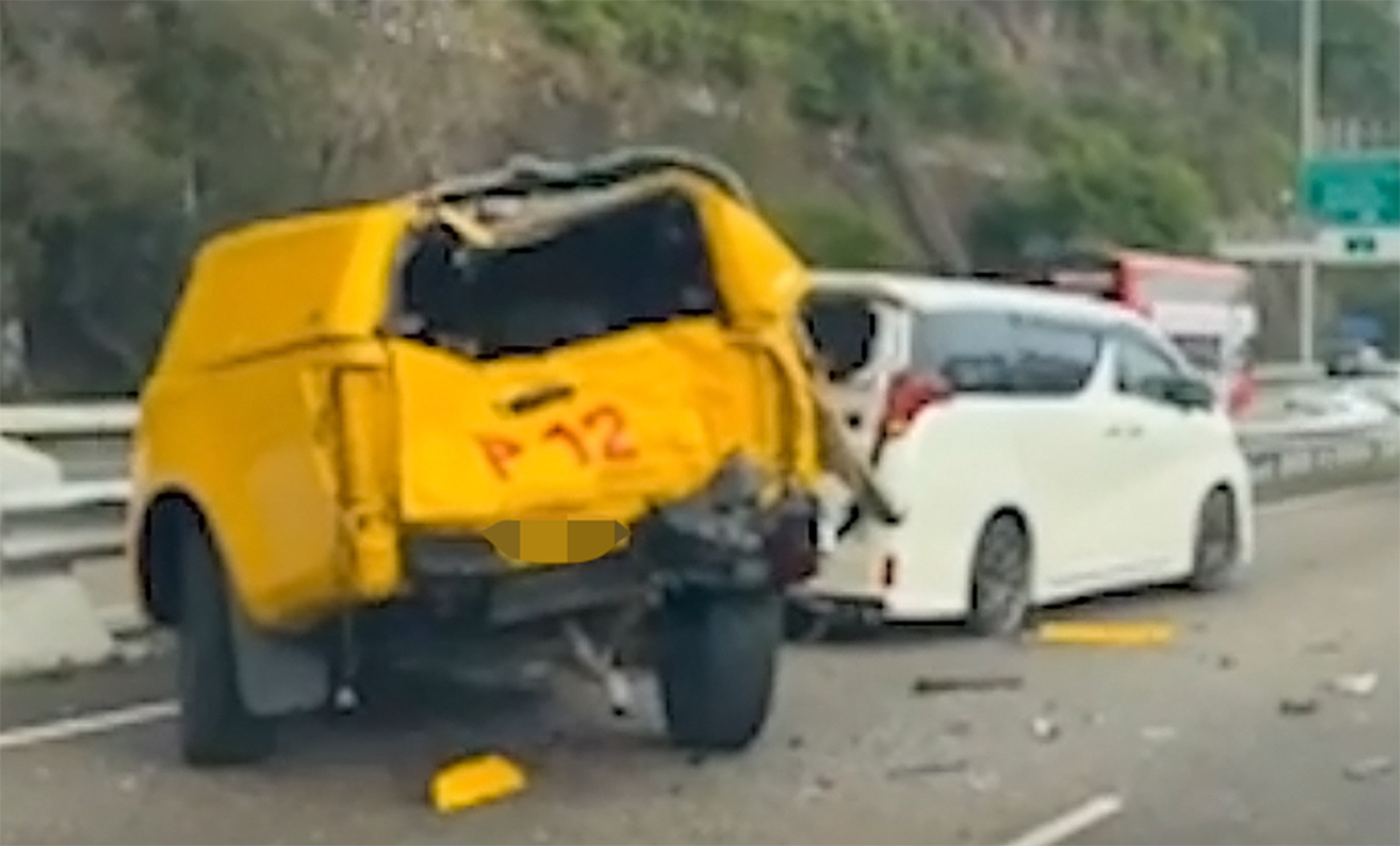 The crushed back of the highway patrol vehicle and the minivan carrying the tourists on Cheung Tsing Highway. Photo: Handout