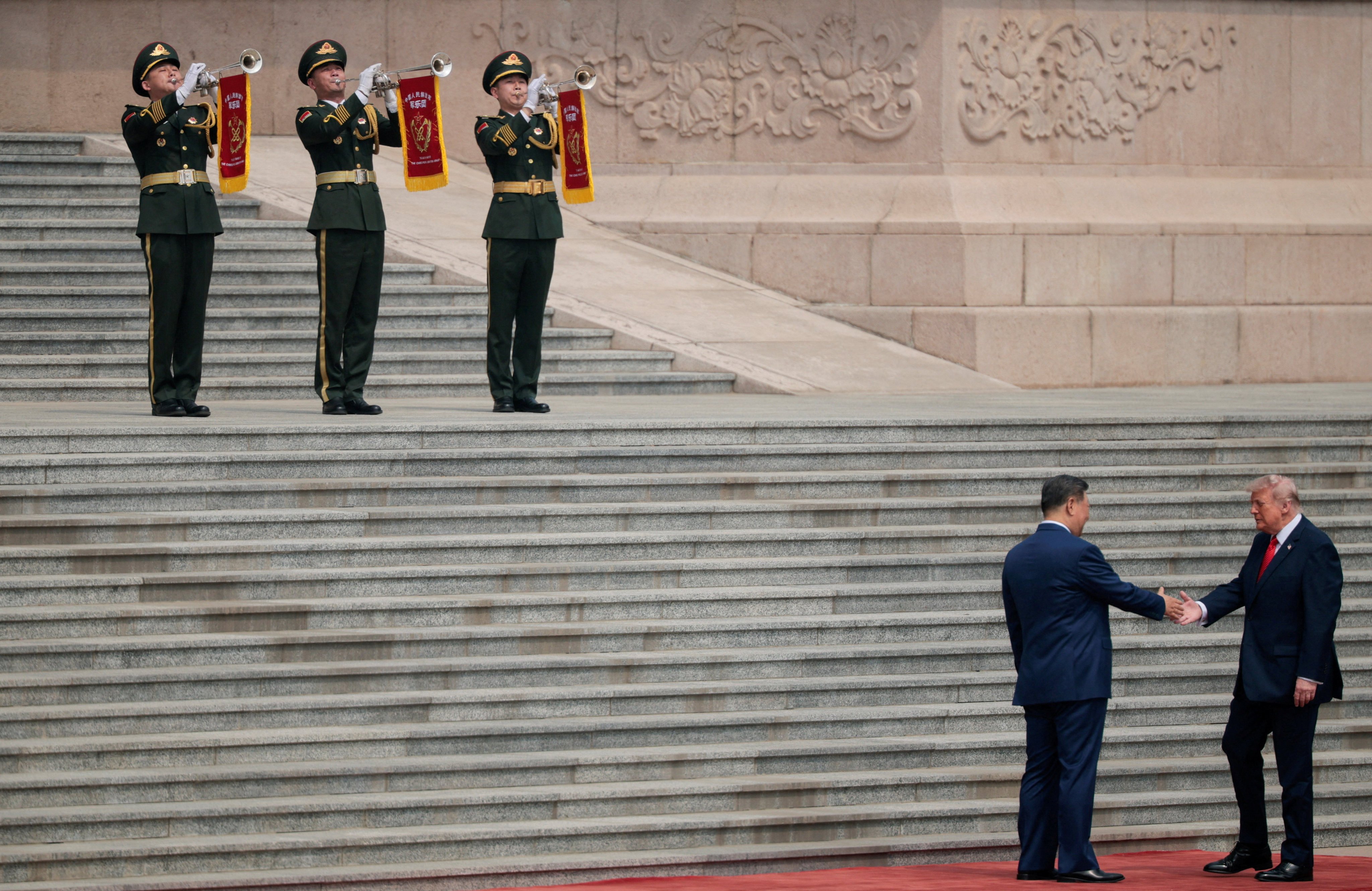 US President Donald Trump (bottom right) shakes hands with Chinese President Xi Jinping upon arriving at the Great Hall of the People in Beijing on May 14. Photo: Reuters