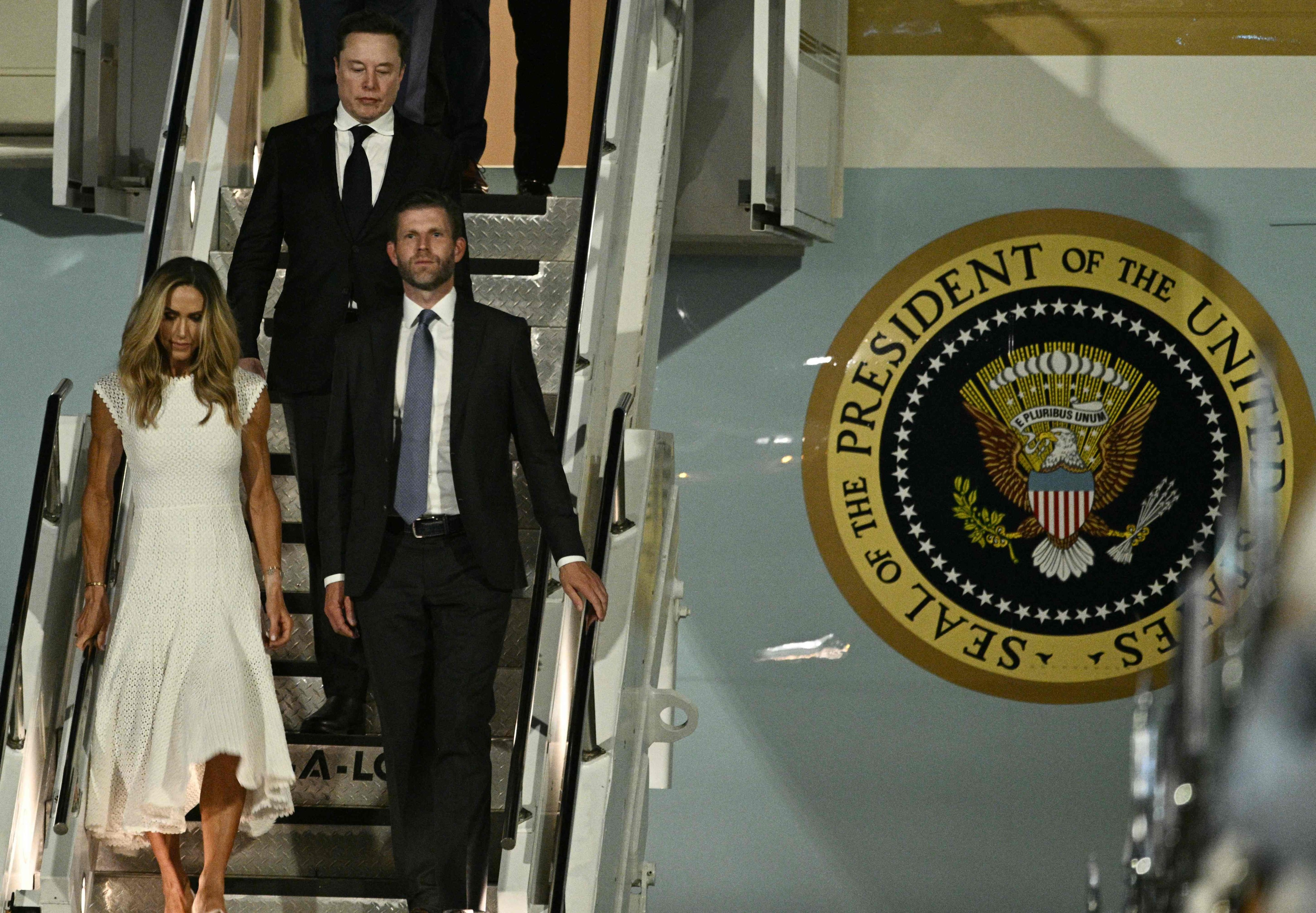 Eric and Lara Trump walk off Air Force One upon arriving at Beijing Capital International  Airport on Wednesday. Photo: AFP