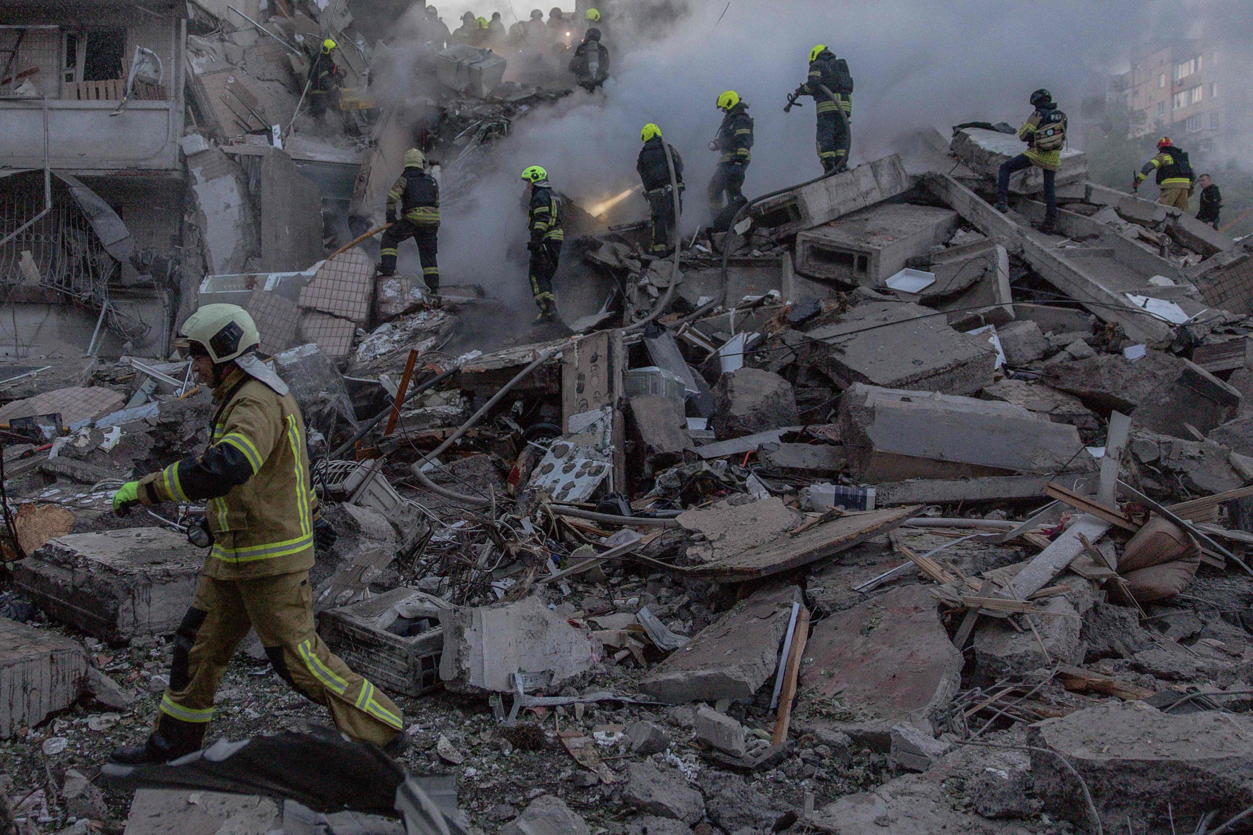 Rescue teams search through rubble in Kyiv. Photo: AFP