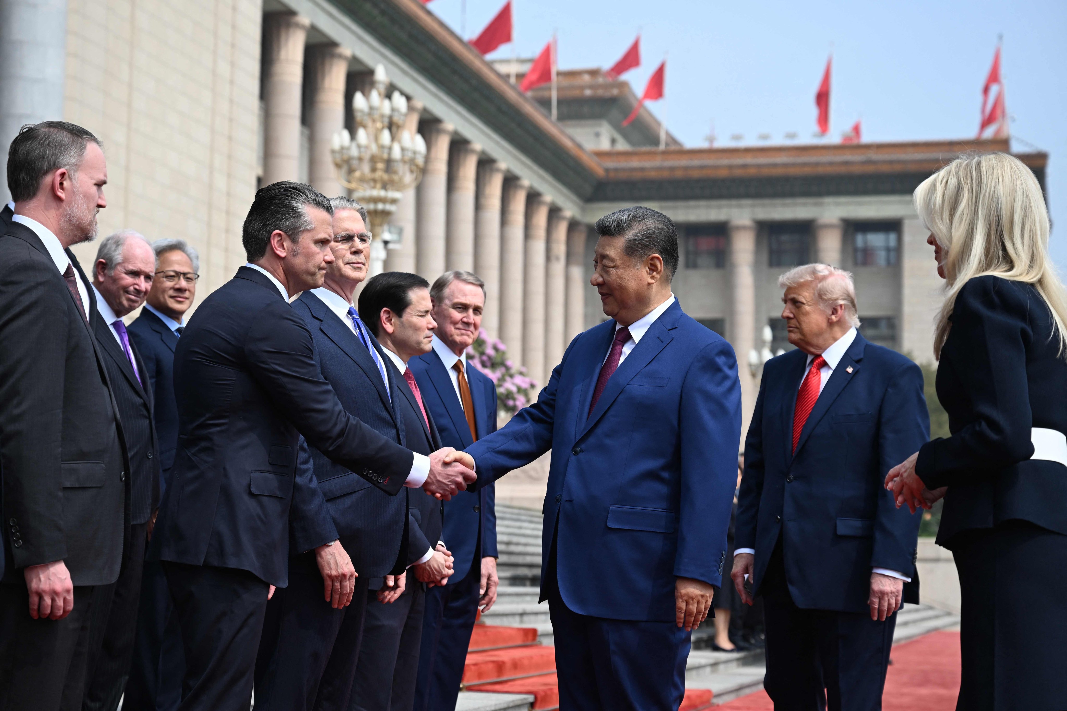 Chinese President Xi Jinping shakes hands with US Secretary of Defence Pete Hegseth as US President Donald Trump looks on, during a welcome ceremony at the Great Hall of the People in Beijing on Thursday. Photo: AFP