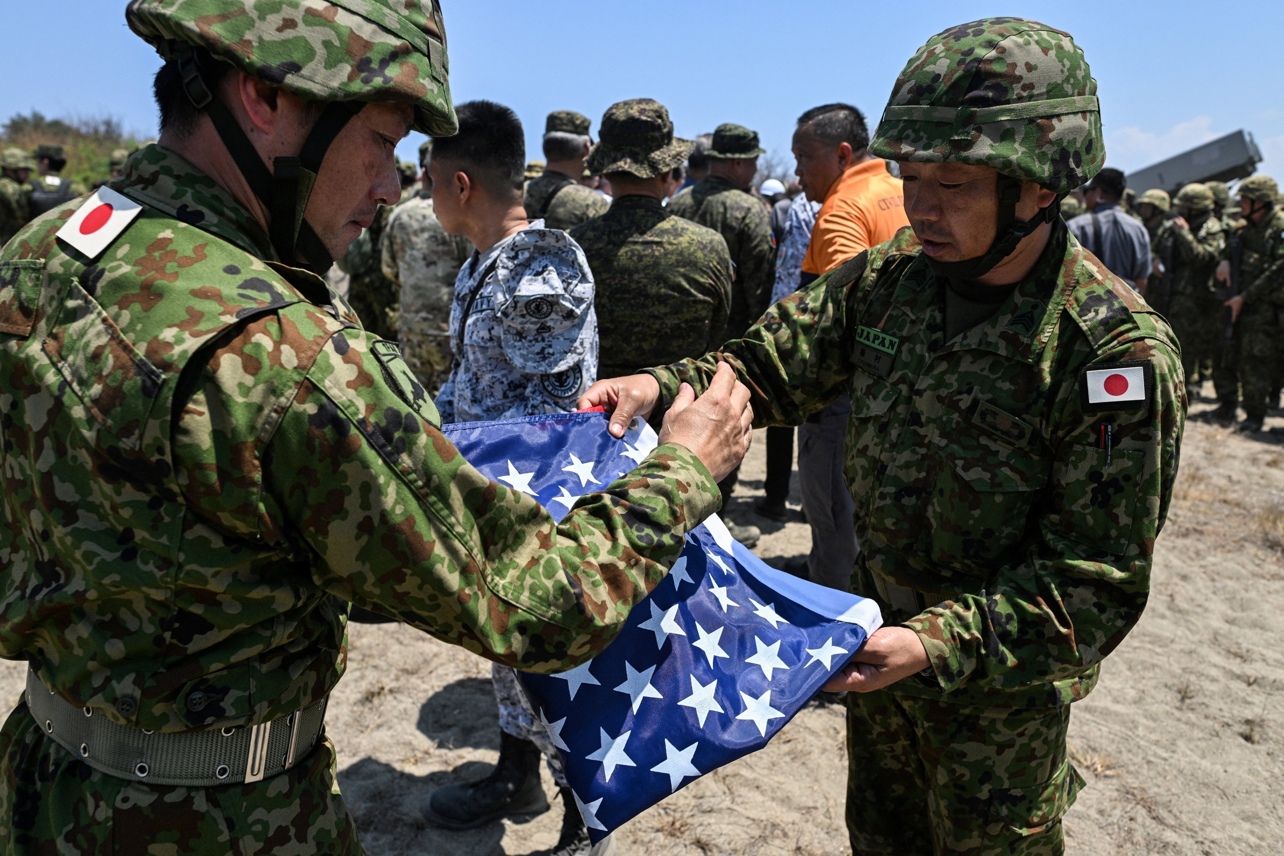 Japan Ground Self-Defence Force soldiers fold a US flag during a Balikatan drill in the Philippines on May 6. Photo: Reuters
