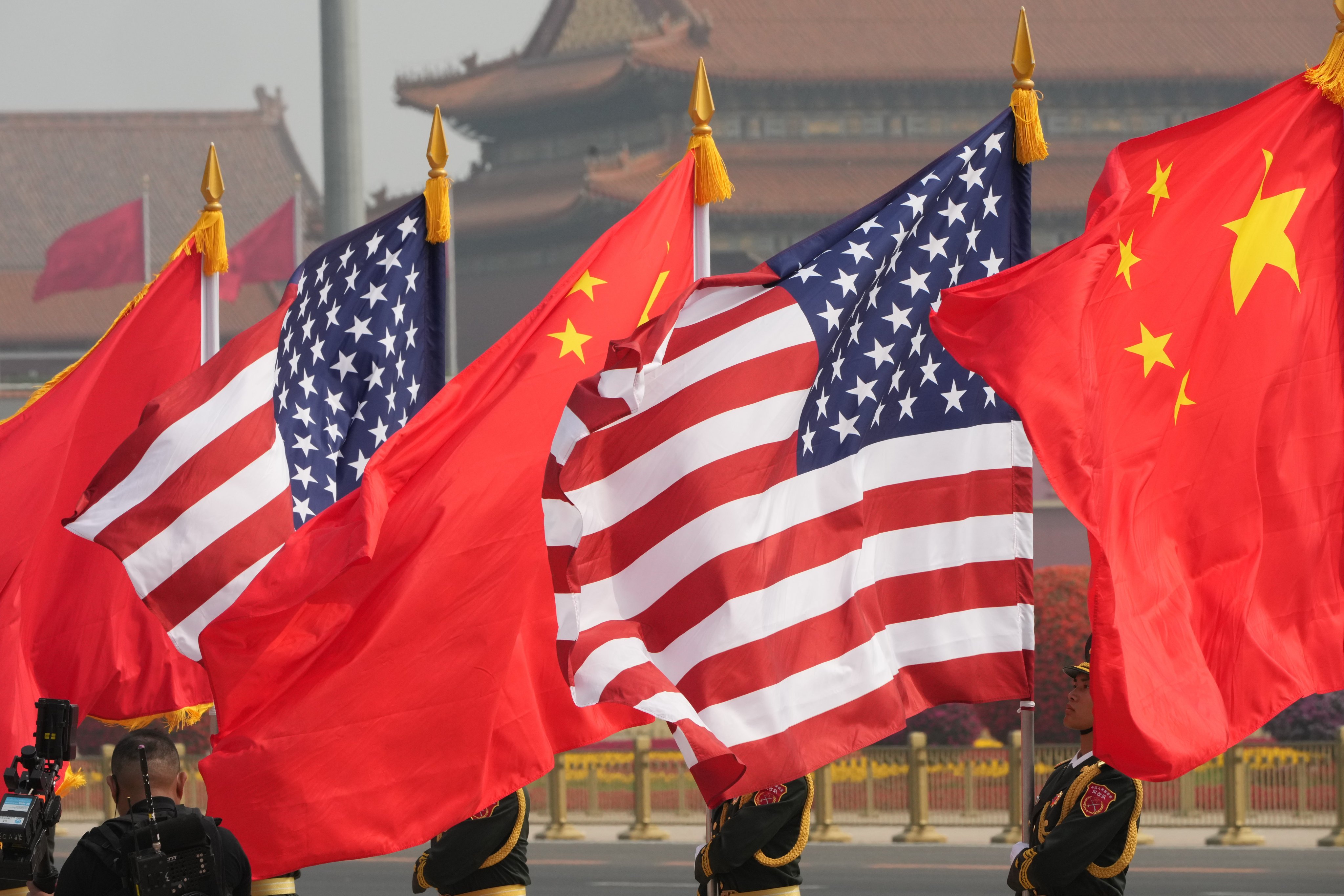 Members of the military honour guard hold American and Chinese flags at the Great Hall of the People. Photo: AP