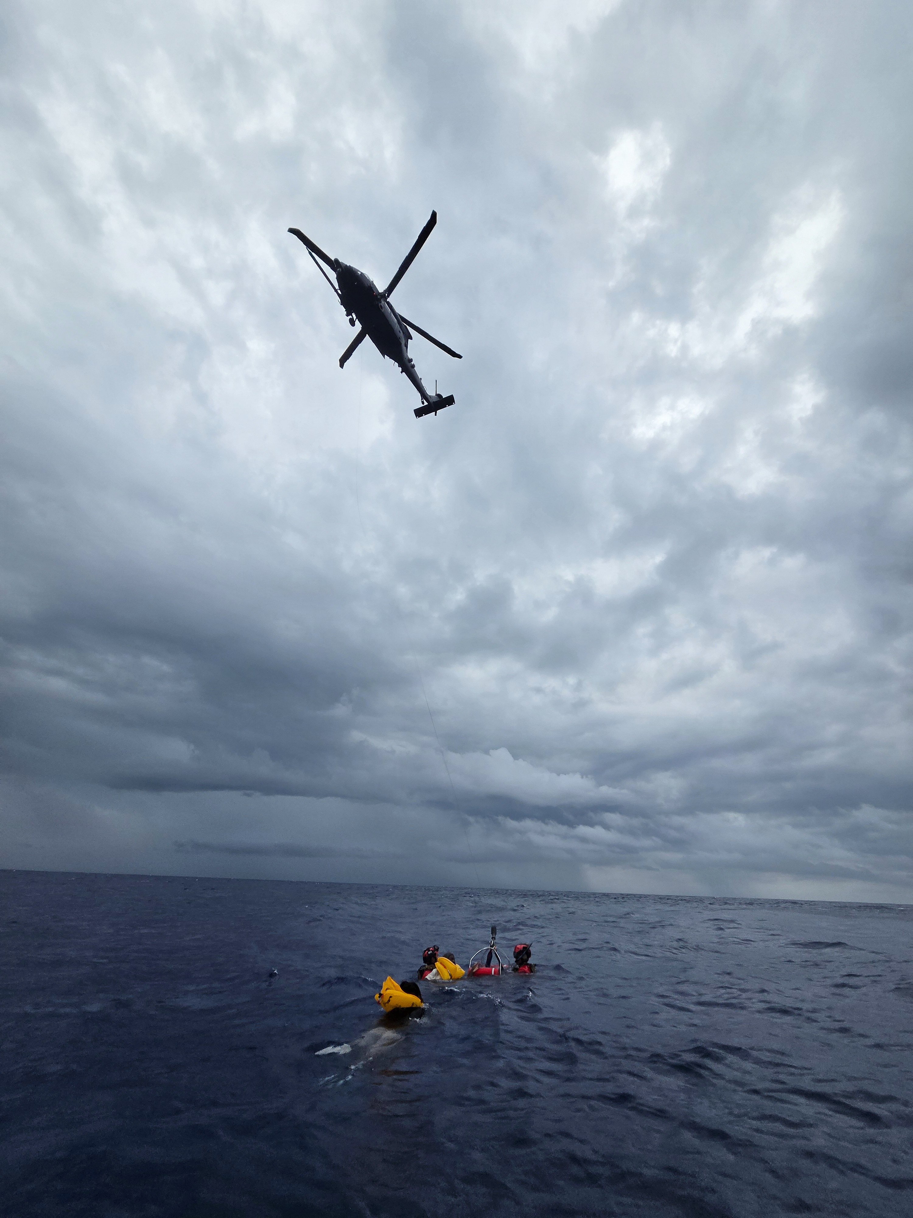 The survivors being hoisted to safety. Photo: US Air Force via AP)