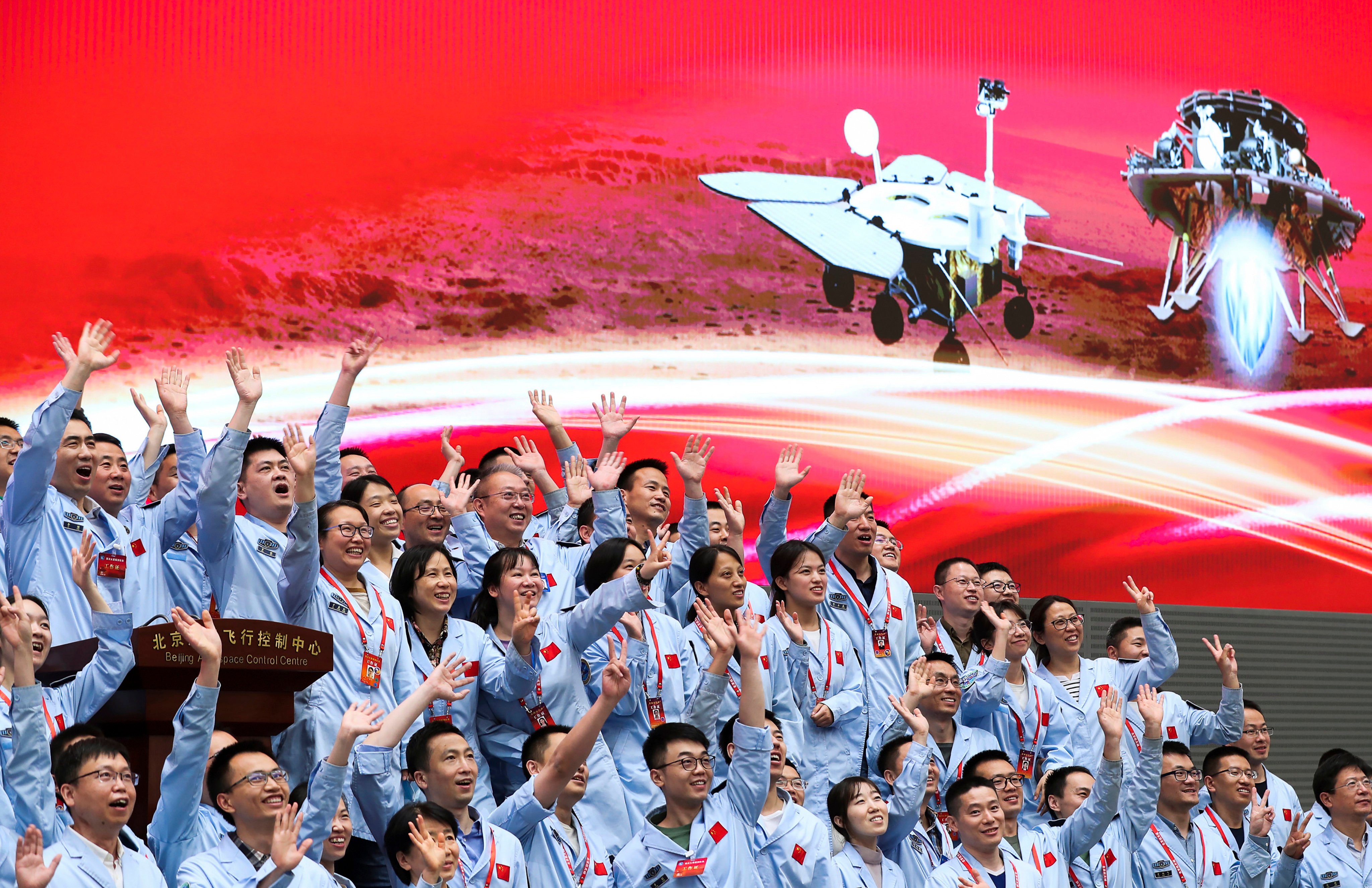 Personnel at the Beijing Aerospace Control Centre celebrate after the Tianwen-1 probe’s lander successfully descended to Mars, carrying the Zhu Rong rover. Photo: Xinhua