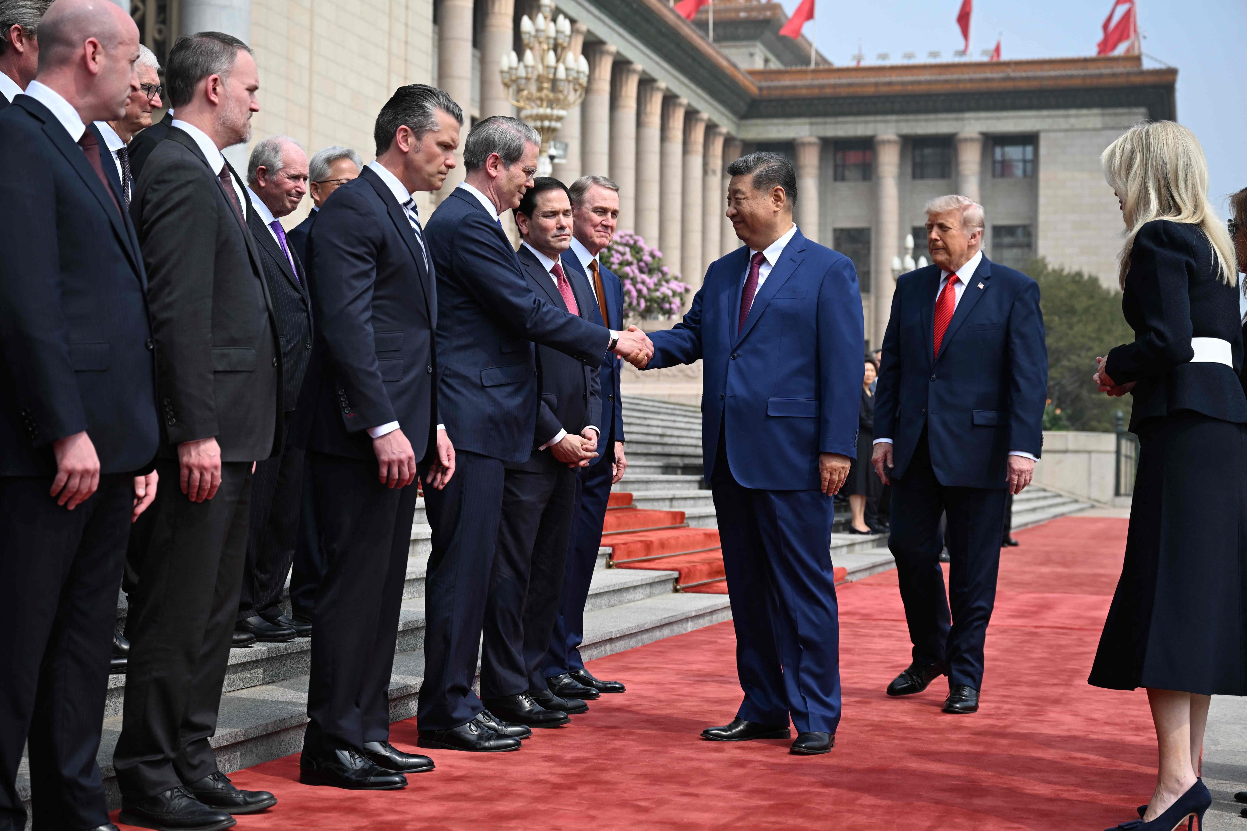 President Xi Jinping shakes hands with US Treasury Secretary Scott Bessent as US President Donald Trump looks on during a welcome ceremony at the Great Hall of the People in Beijing on Thursday. Photo: AFP