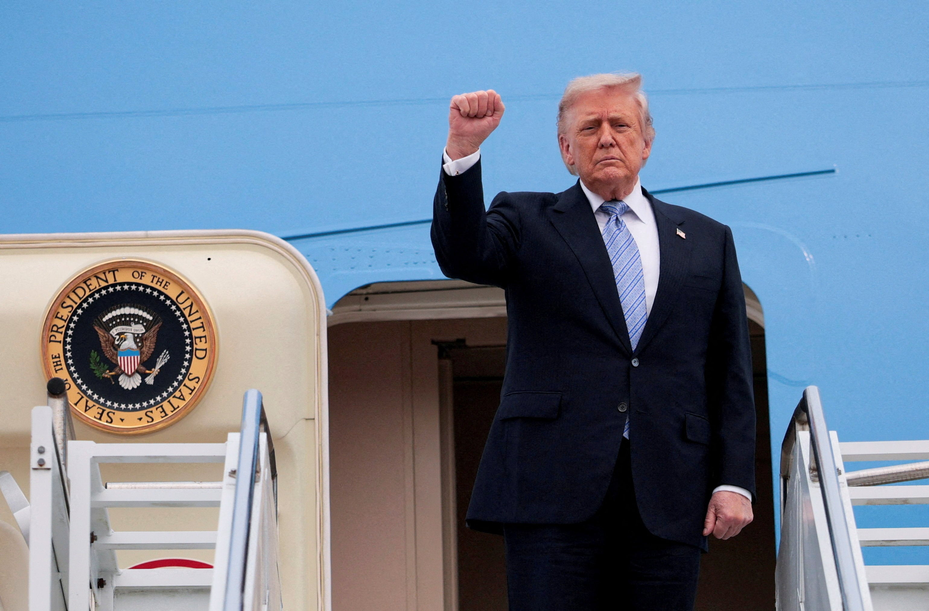 US President Donald Trump gestures as he departs Beijing Capital International Airport aboard Air Force One, in Beijing on Friday. Photo: Reuters