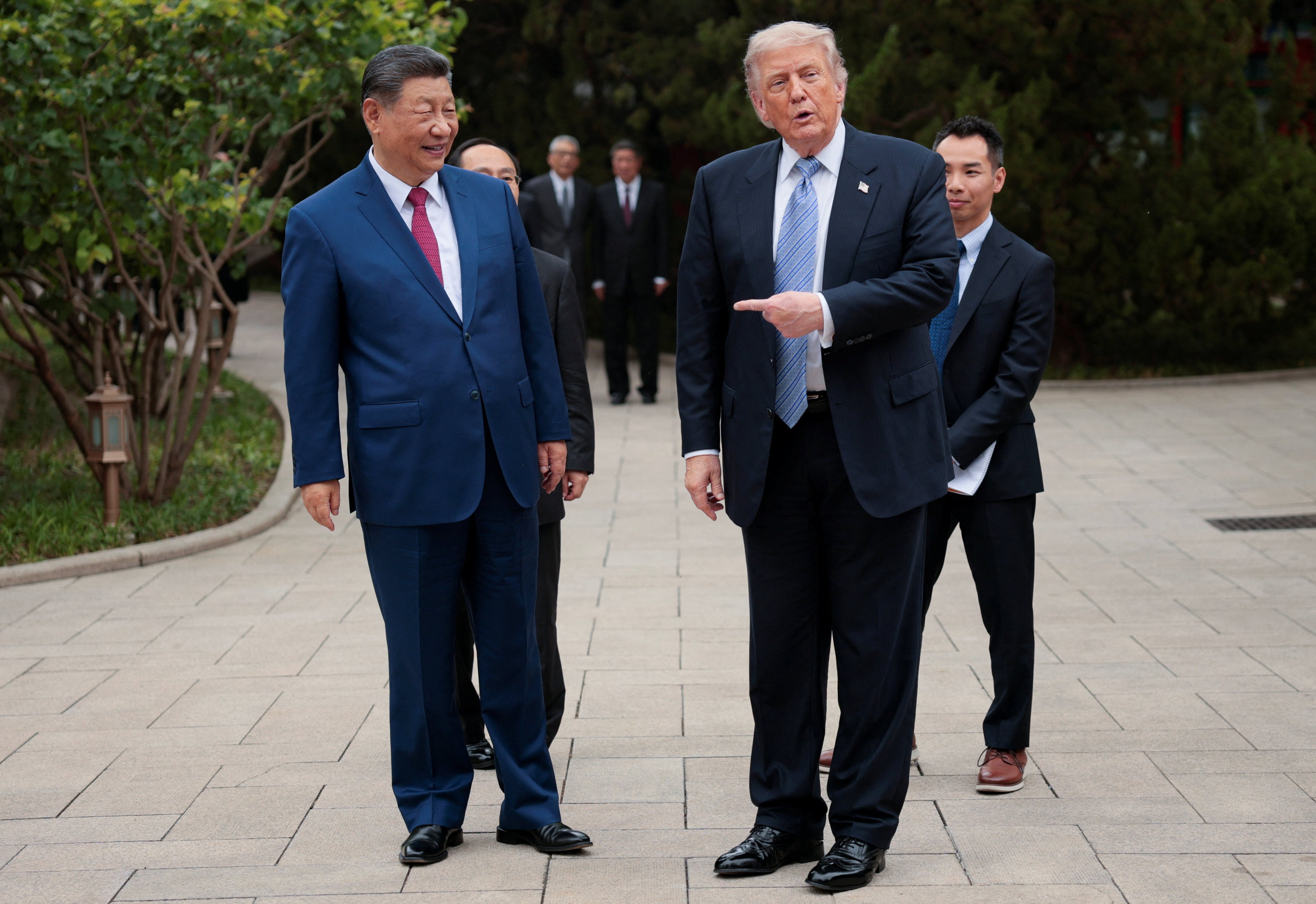 US President Donald Trump gestures towards Chinese President Xi Jinping during a visit to gardens in the Zhongnanhai leadership compound in Beijing. Photo: Reuters