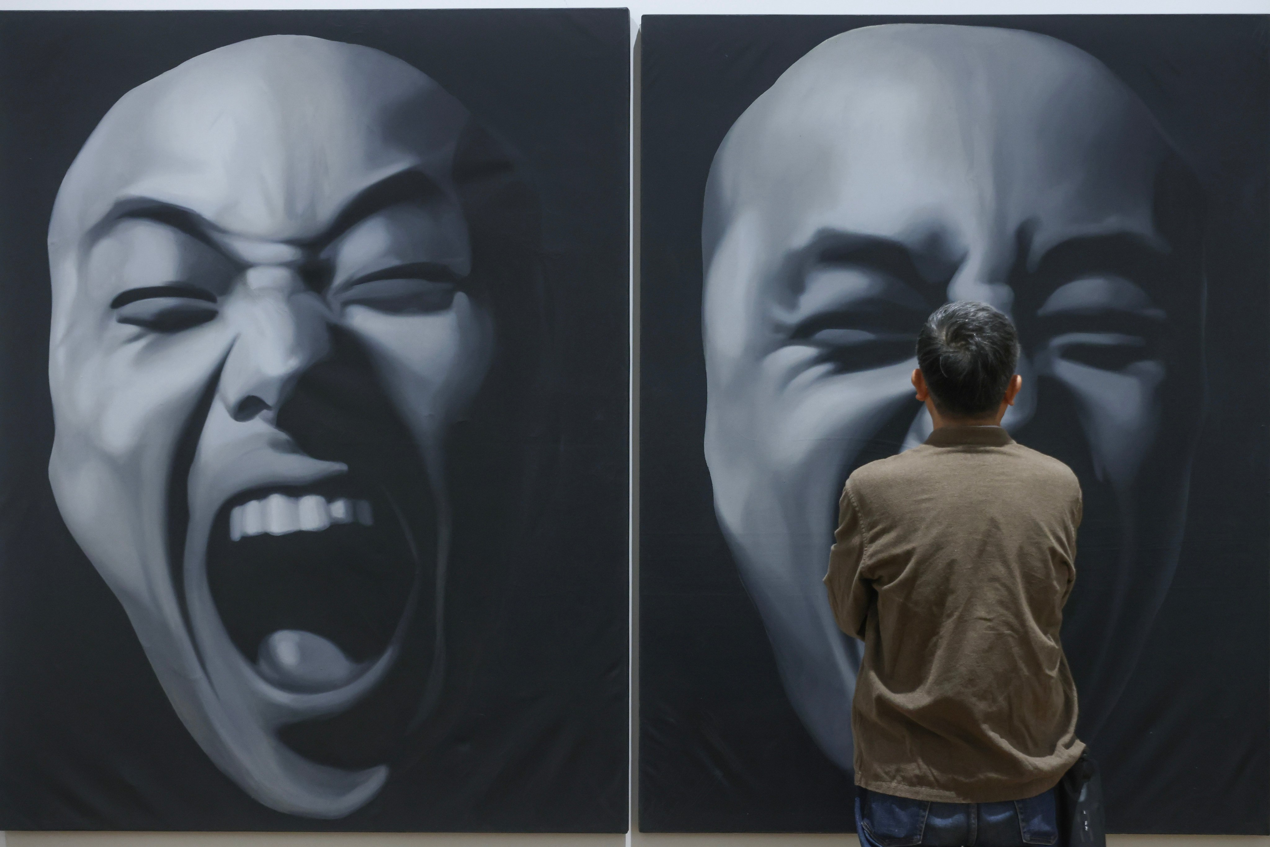 A visitor to the M+ looks at The Second State by Geng Jianyi. Photo: Jonathan Wong