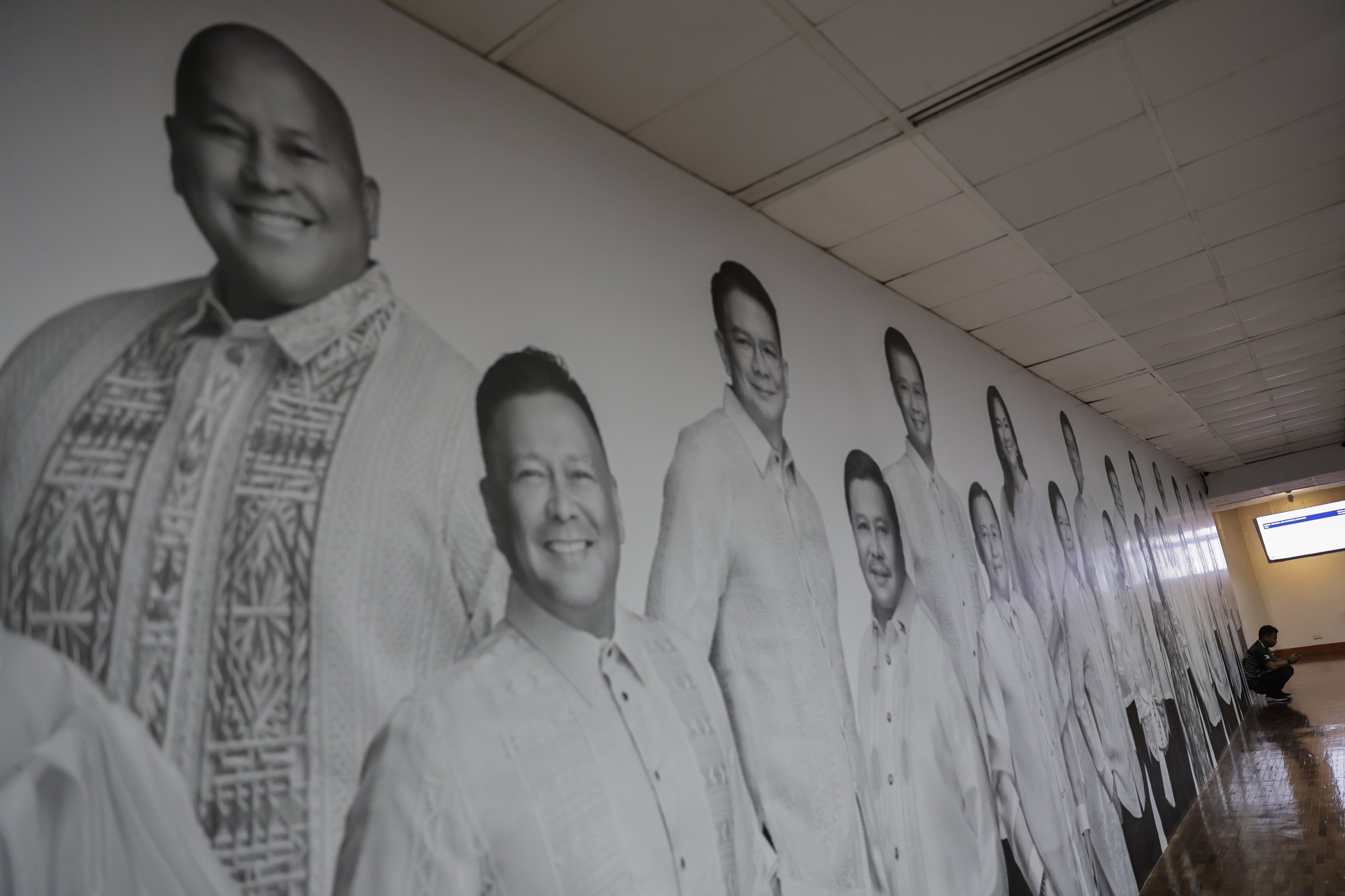 A hallway at the Philippine Senate in Pasay City, Metro Manila, displays images of incumbent legislators, including Senator Ronald “Bato” dela Rosa (top left). Photo: EPA