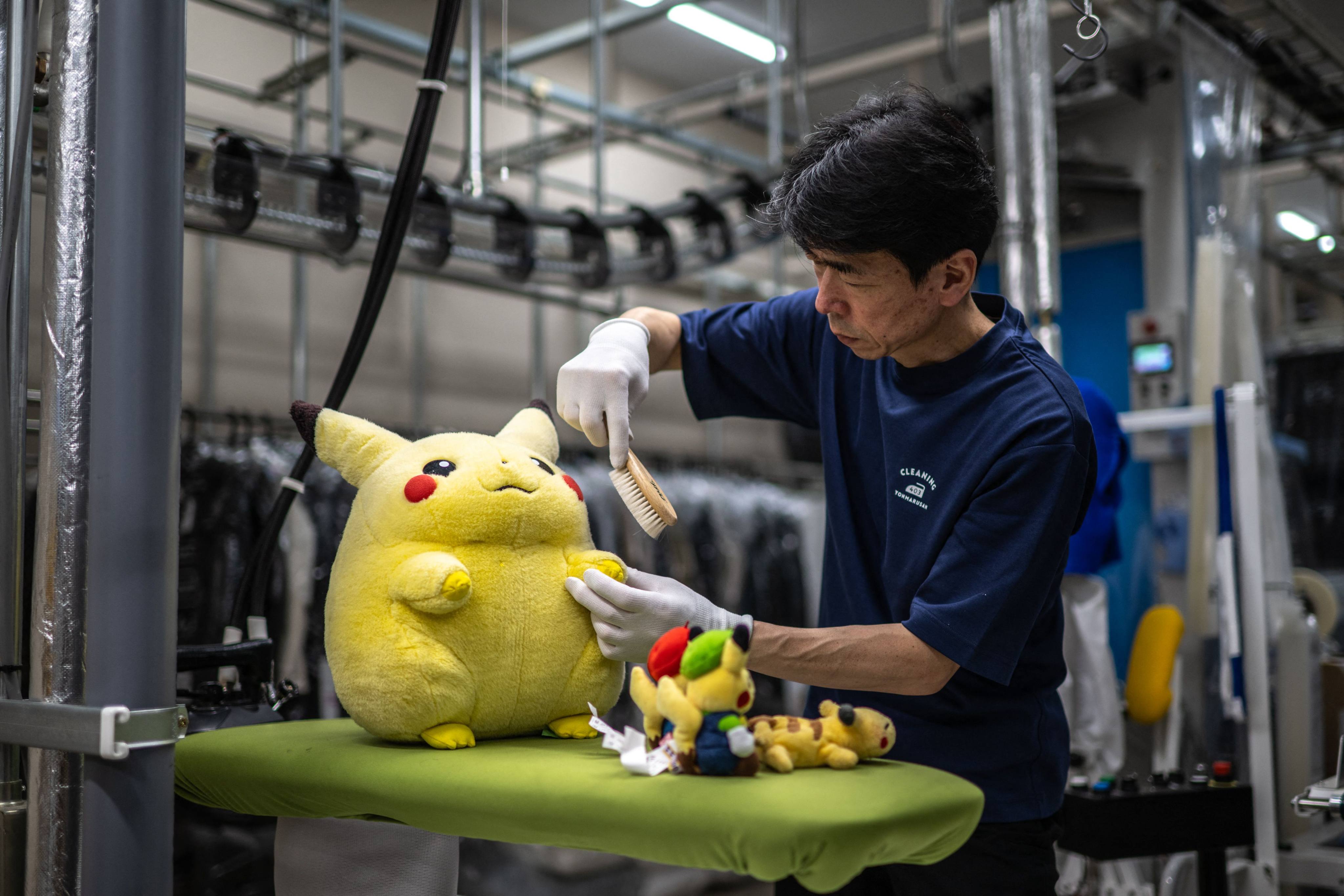 Masakazu Shimura brushes a Pikachu toy at Cleaning Yonmarusan in Fuefuki city, Yamanashi Prefecture, Japan. Photo: AFP
