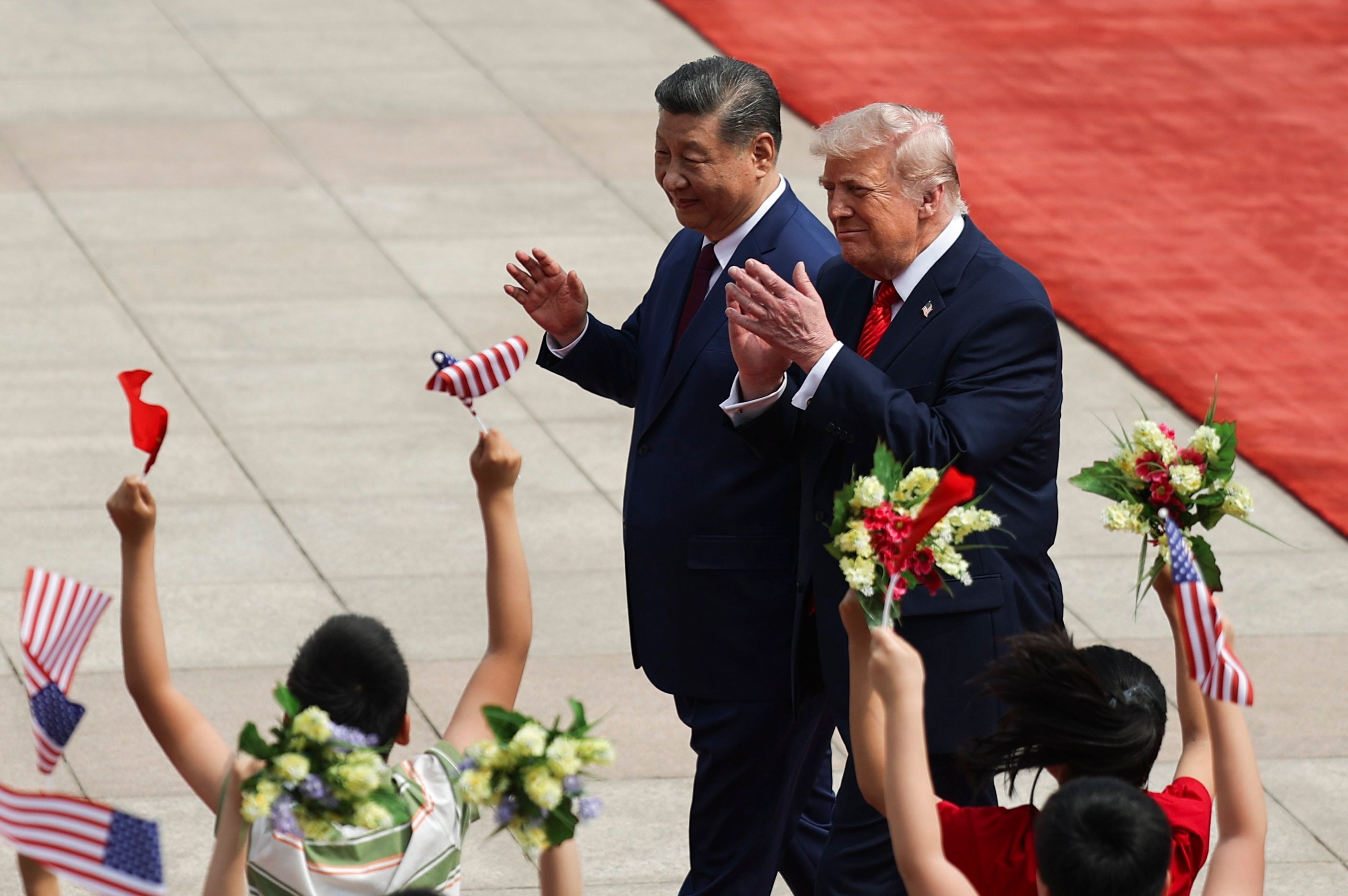 Chinese President Xi Jinping and US President Donald Trump are greeted by children during a welcome ceremony at the Great Hall of the People in Beijing on May 14, 2026. Photo: Pool via EPA
