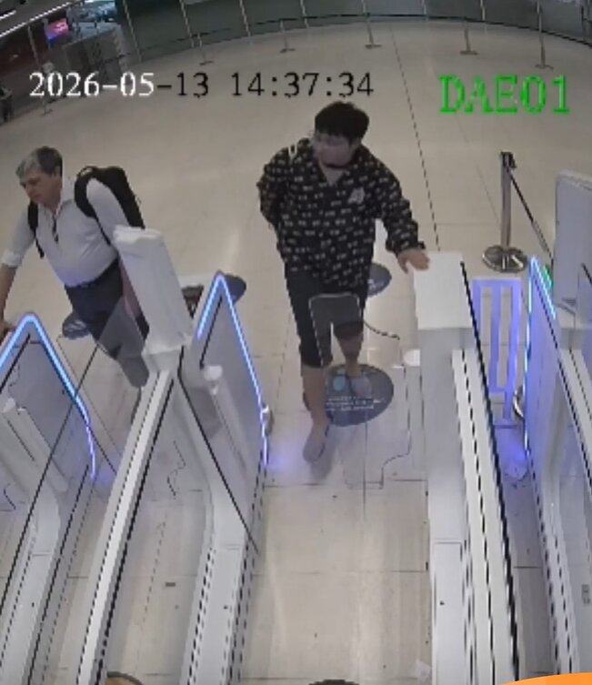 The tourist is seen on CCTV kicking the autogates when they do not open for him. Photo: Handout