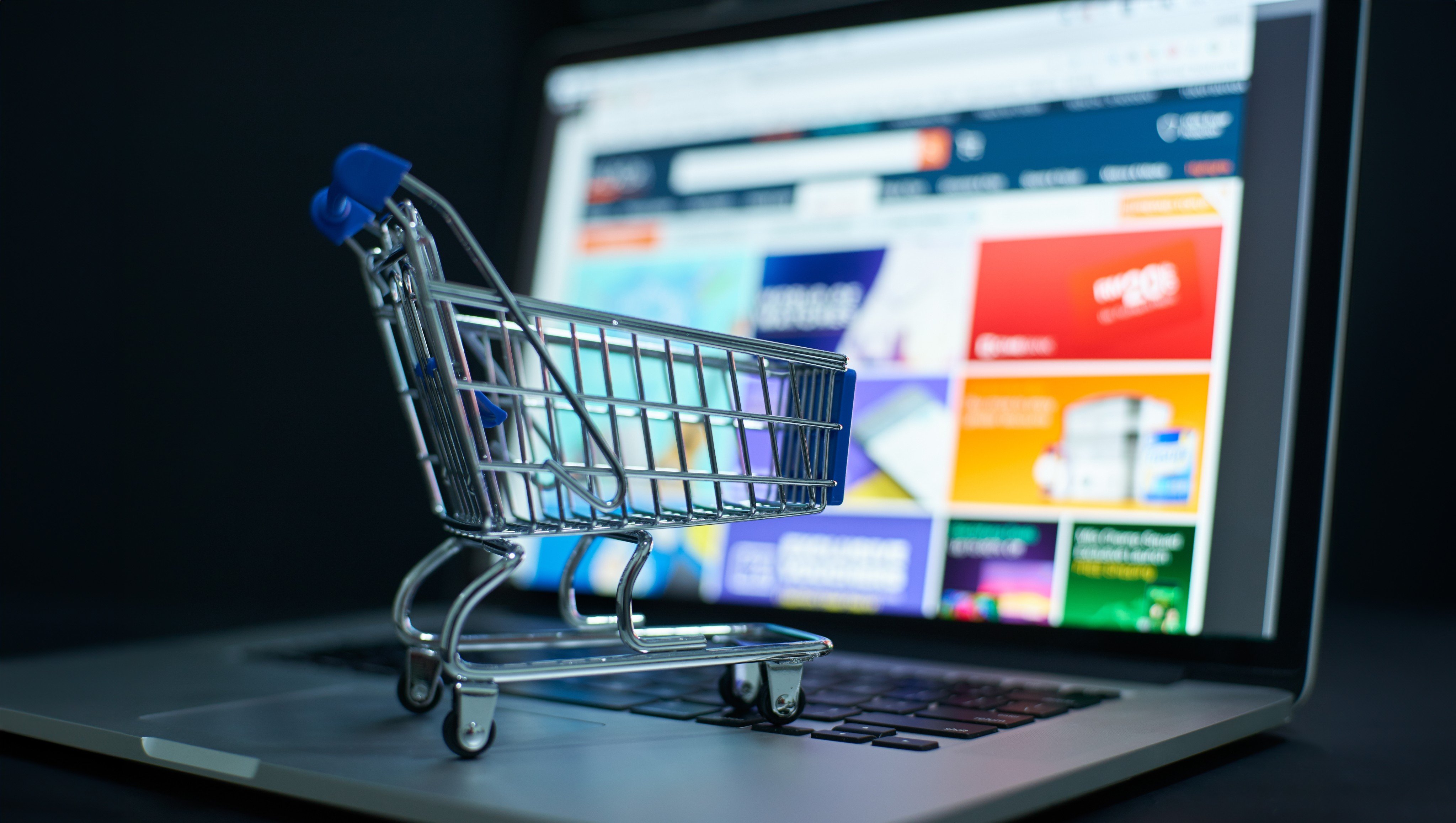 Small shopping cart on a laptop keyboard signifies convenience in digital purchases. Photo: Shutterstock Images
