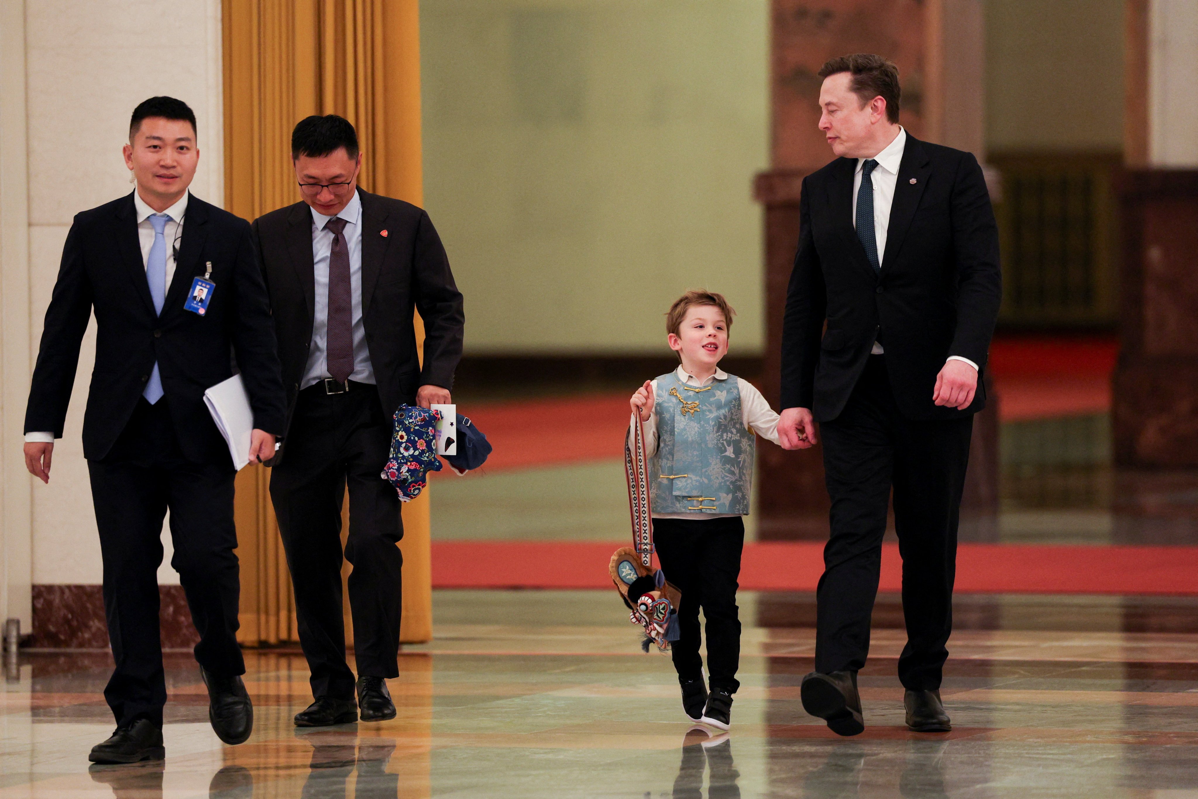 The six-year-old was seen carrying the bag at the Great Hall of the People in Beijing. Photo: Reuters