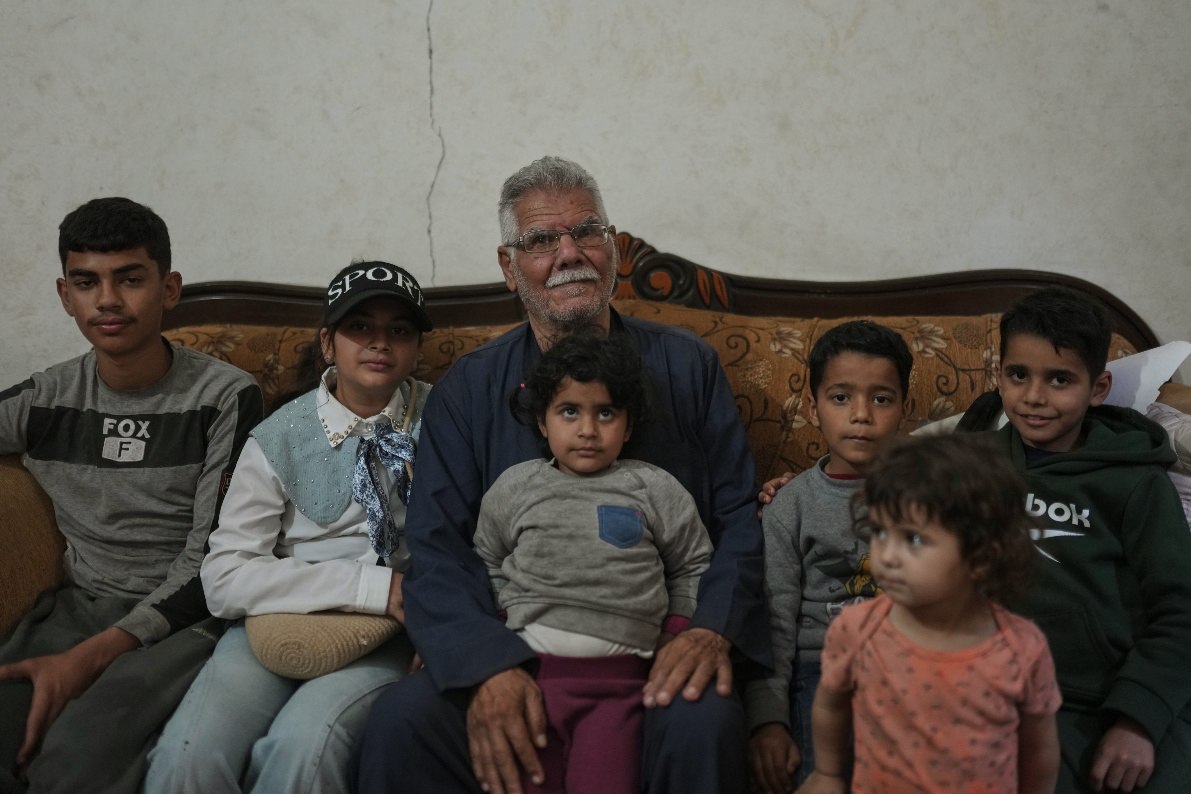 Palestinian Yusuf Abu Hamam, centre, who was expelled from his town during the first Israeli-Arab war, in 1948, poses for a photograph on Wednesday with his grandchildren at his home in a refugee camp in Gaza. Photo: AP