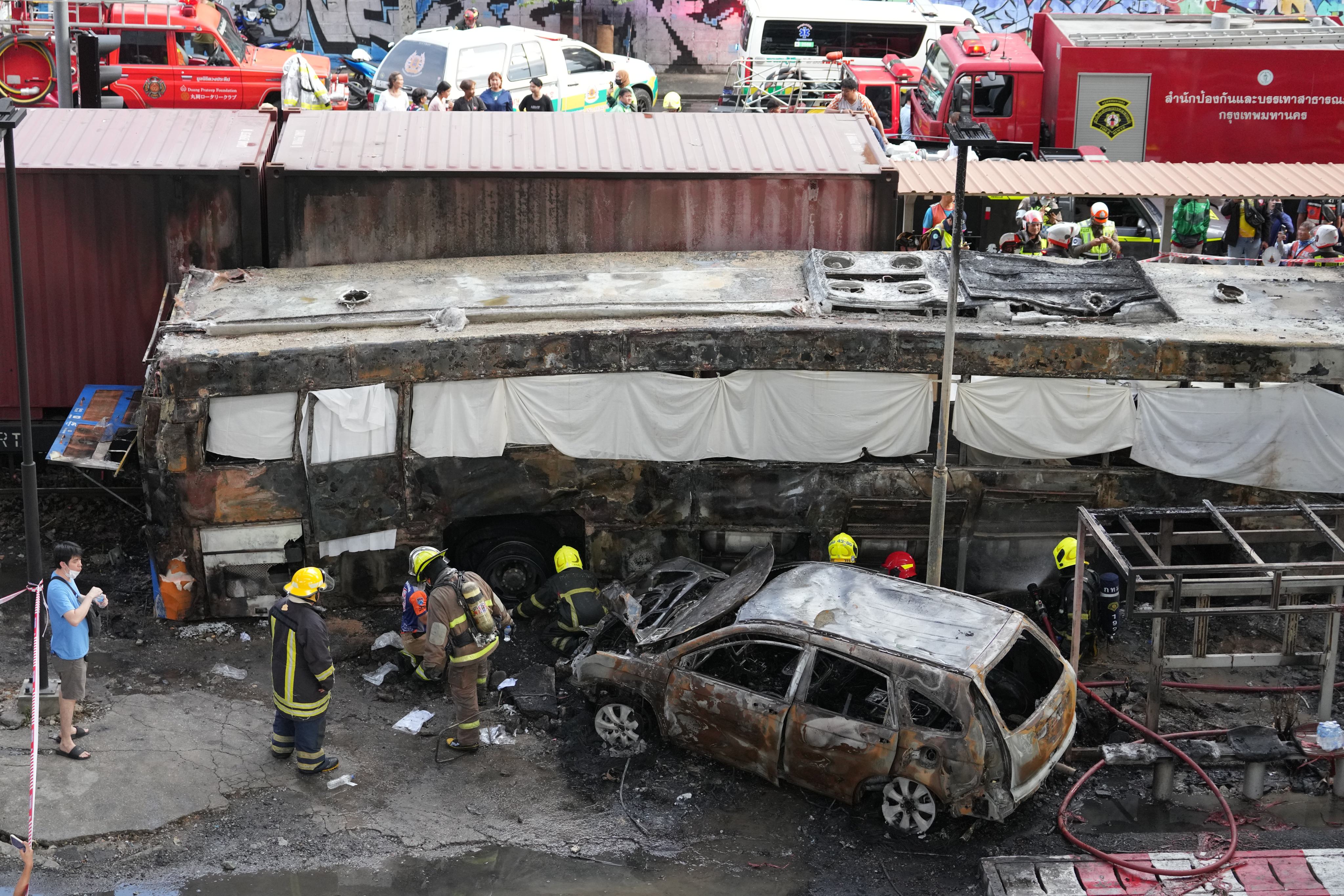 Rescuers work at a train crash site near an airport rail link station in Bangkok, Thailand, on Saturday. Photo: AP