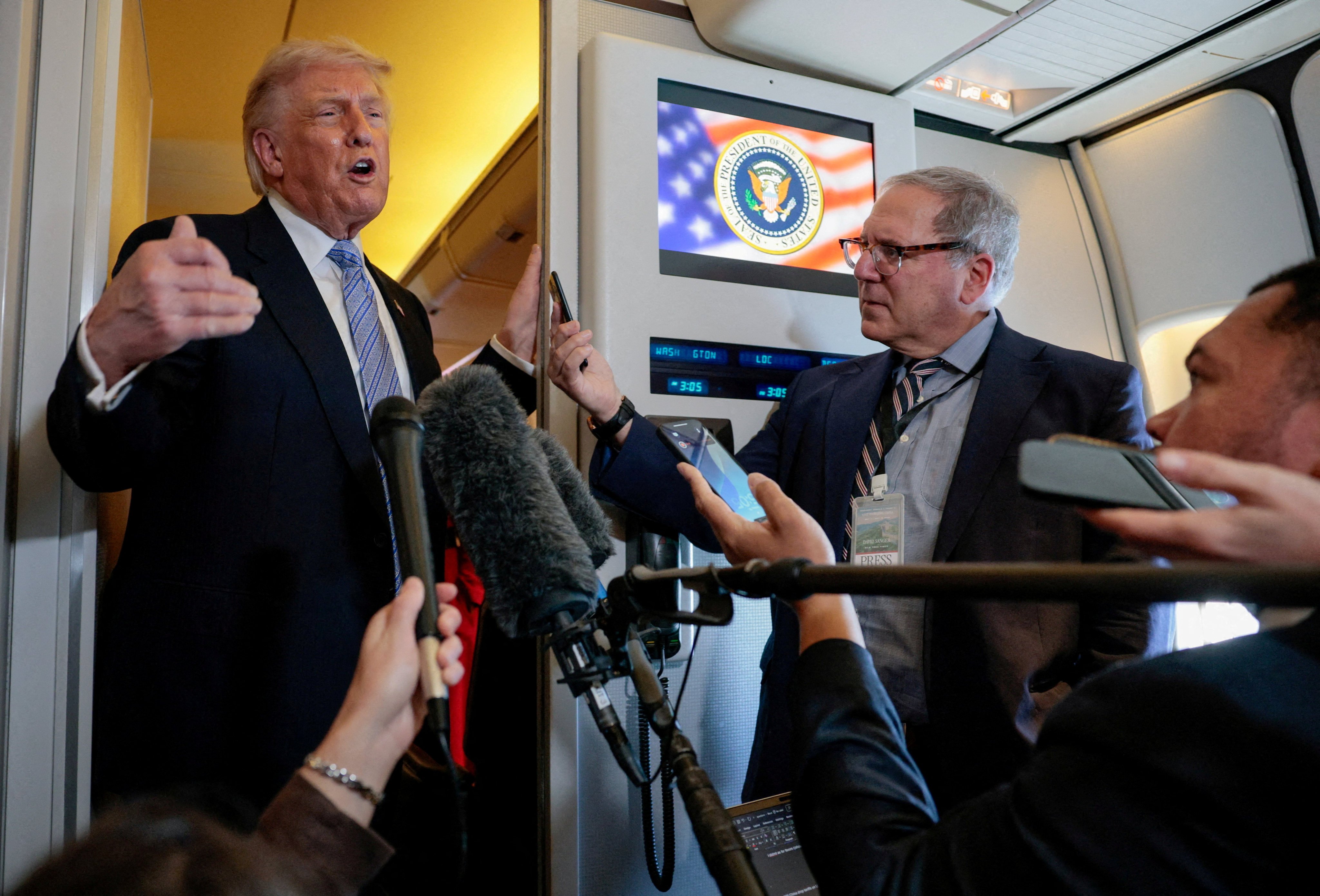 US President Donald Trump speaks to the press aboard Air Force One en route to the US following his official visit with President Xi Jinping in China on Friday. Photo: Reuters