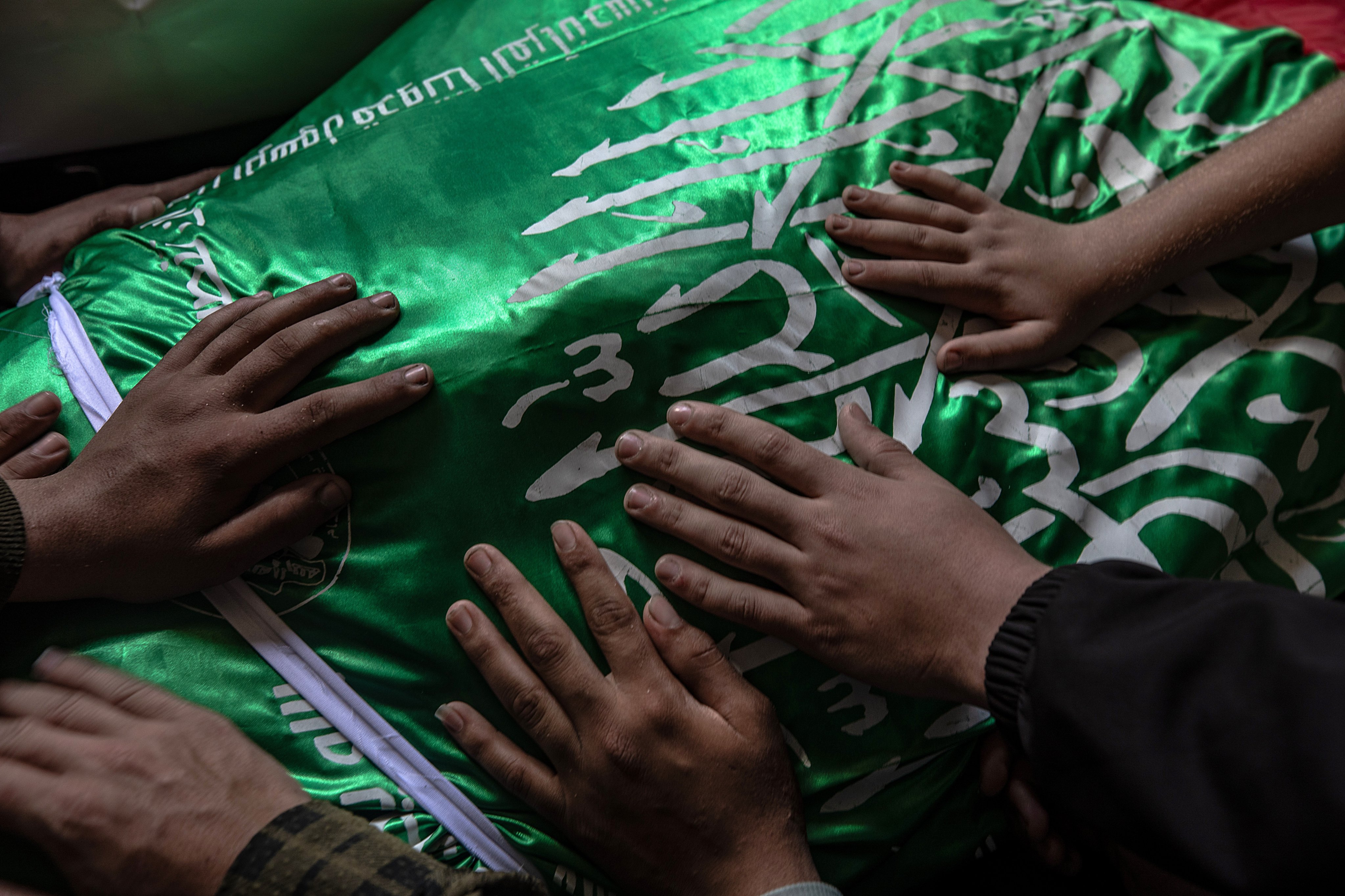 Palestinian relatives mourn over the body of Izz al-Din al-Haddad, the commander of the Al-Qassam Brigades, during his funeral procession in Gaza City on Saturday. Photo: EPA-EFE