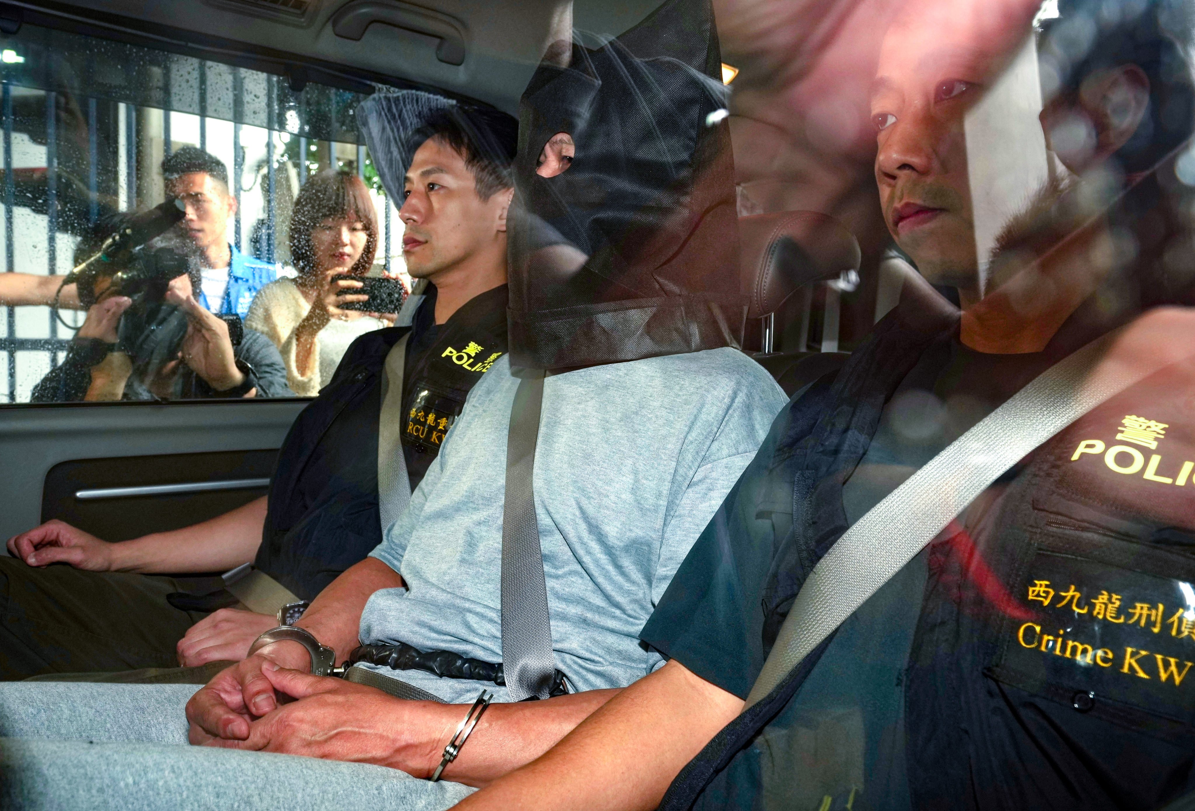 A suspect in the 1999 murder of a newspaper vendor is escorted by police officers. Photo: Sam Tsang
