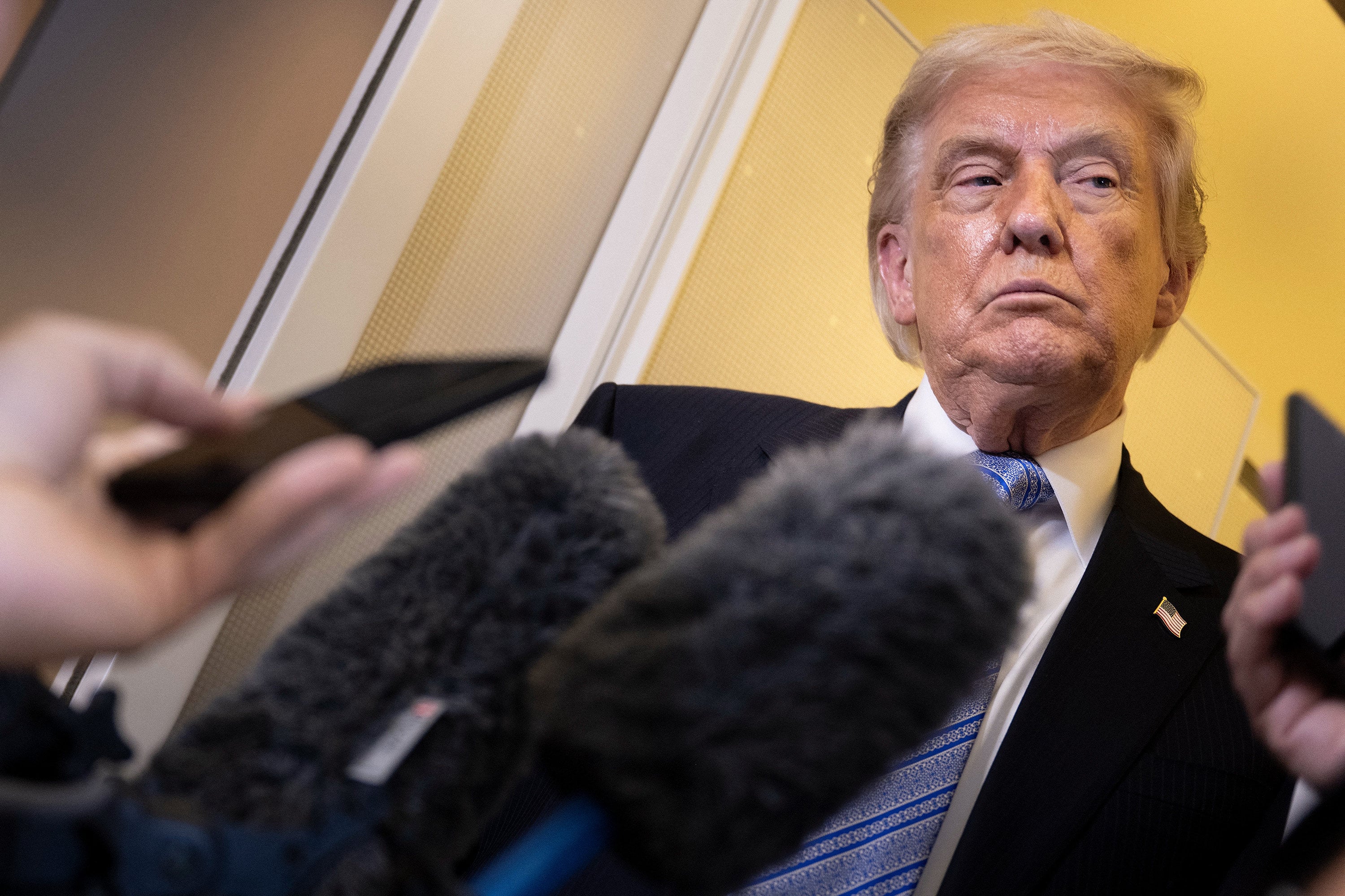 US President Donald Trump speaks to reporters aboard Air Force One after departing Beijing on Friday. Photo: TNS
