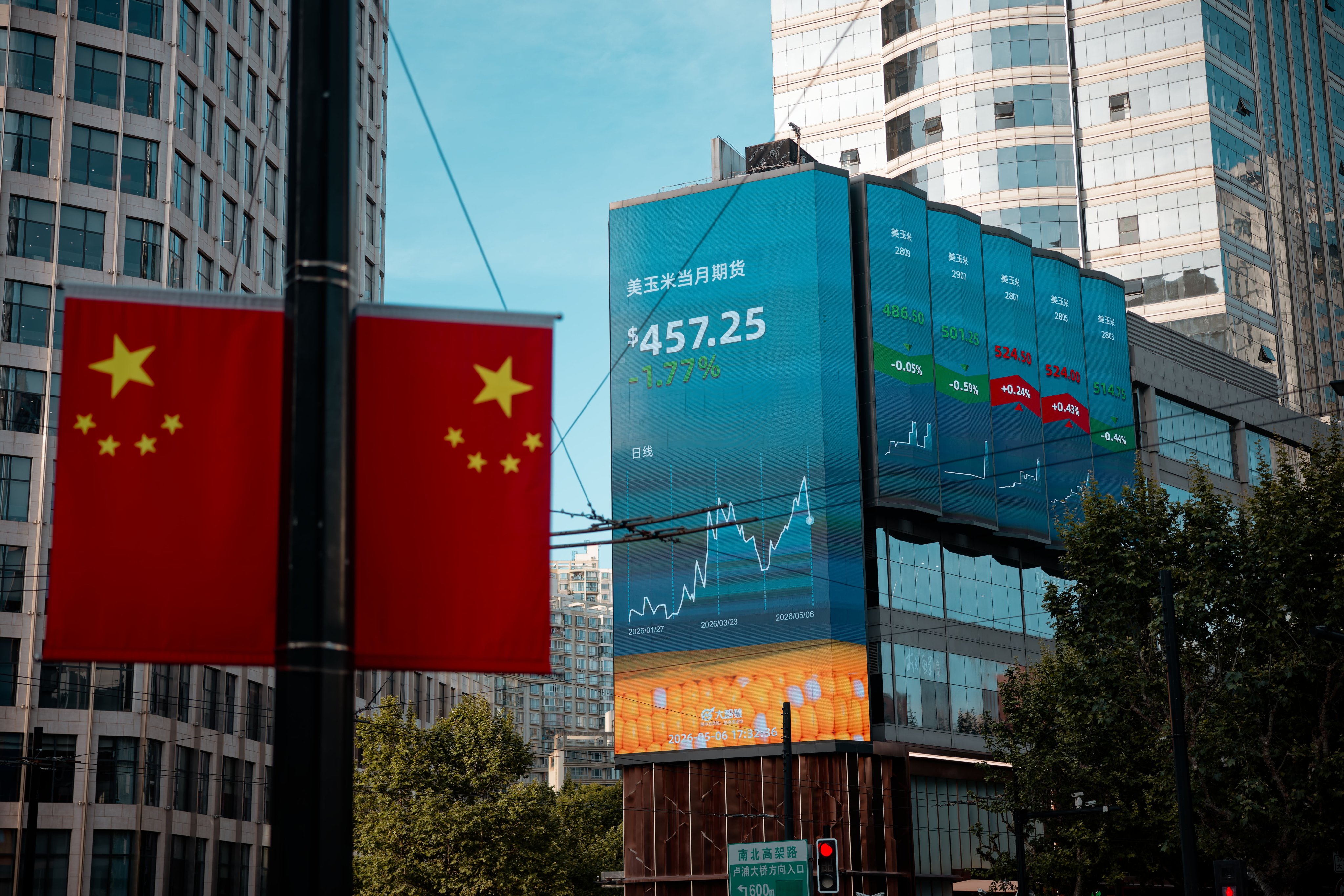 A large screen shows the latest stock exchange and economic data in Shanghai, China. Photo: EPA