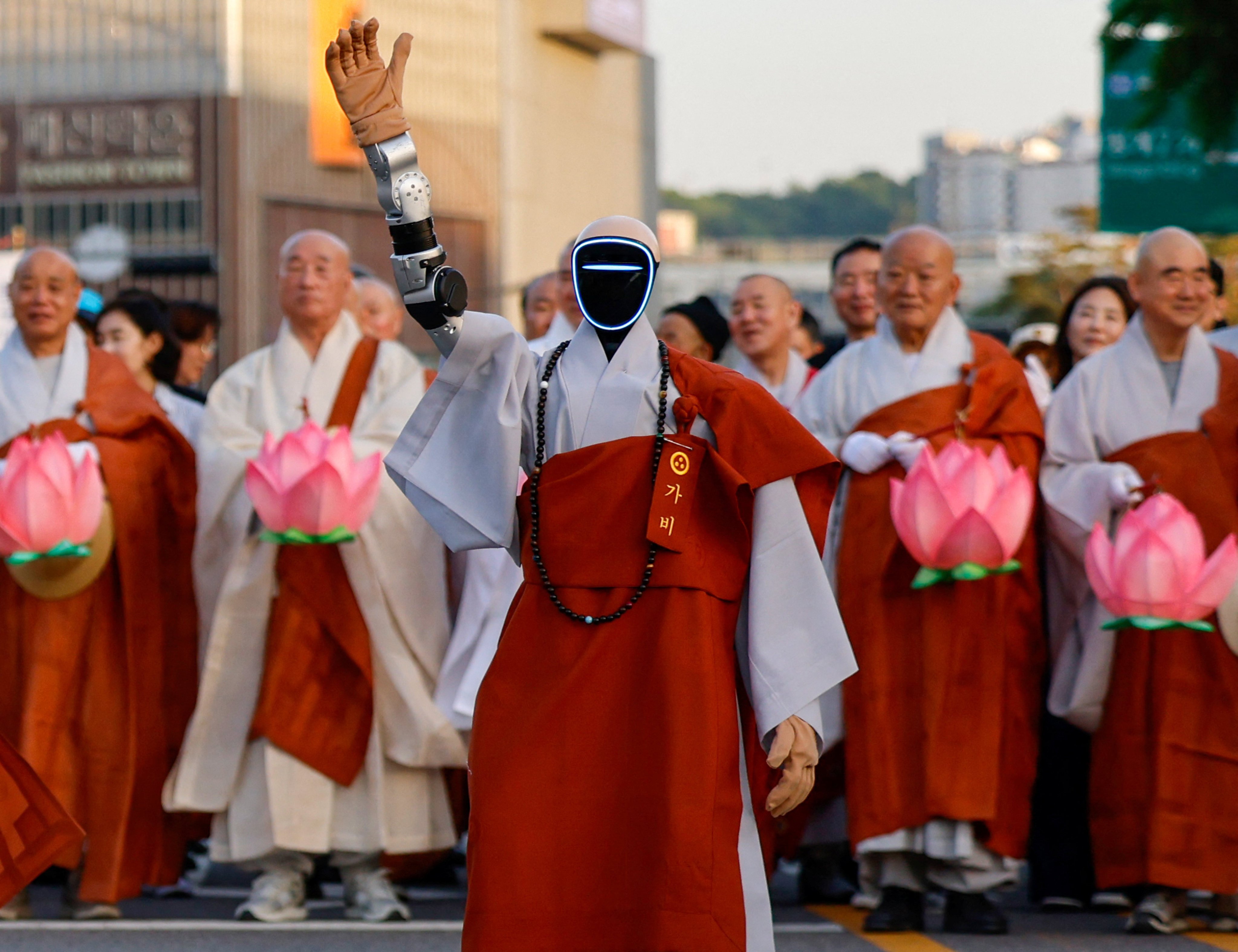An android robot monk waves its hand in front of monks during a Lotus Lantern parade ahead of Buddha's birthday in Seoul, South Korea, May 16, 2026. REUTERS/Kim Soo-hyeon
